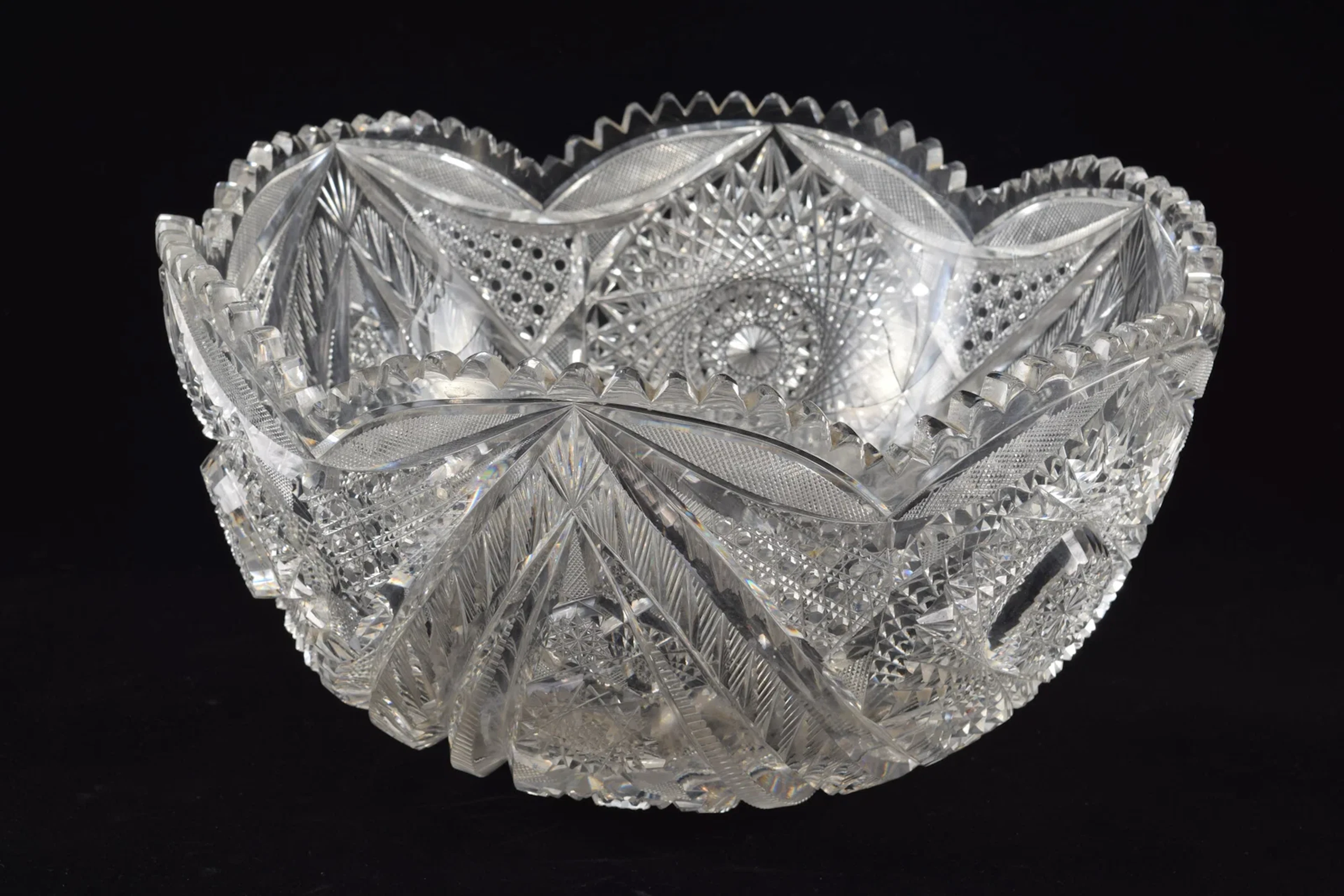 Large cut glass punch bowl with bold pinwheel decorations.. Diameter 14 in.