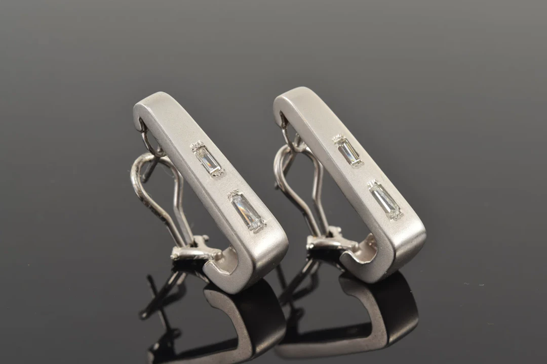 14K white gold diamond earrings. Matte finish J-form clip earrings