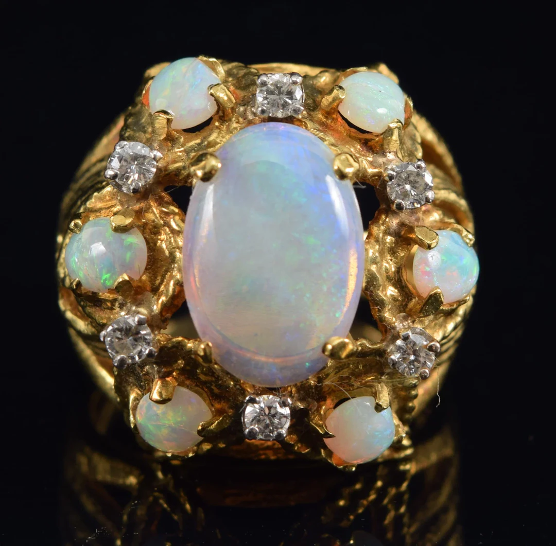 18K gold opal and diamond mounted ring. Openwork foliate design setting.