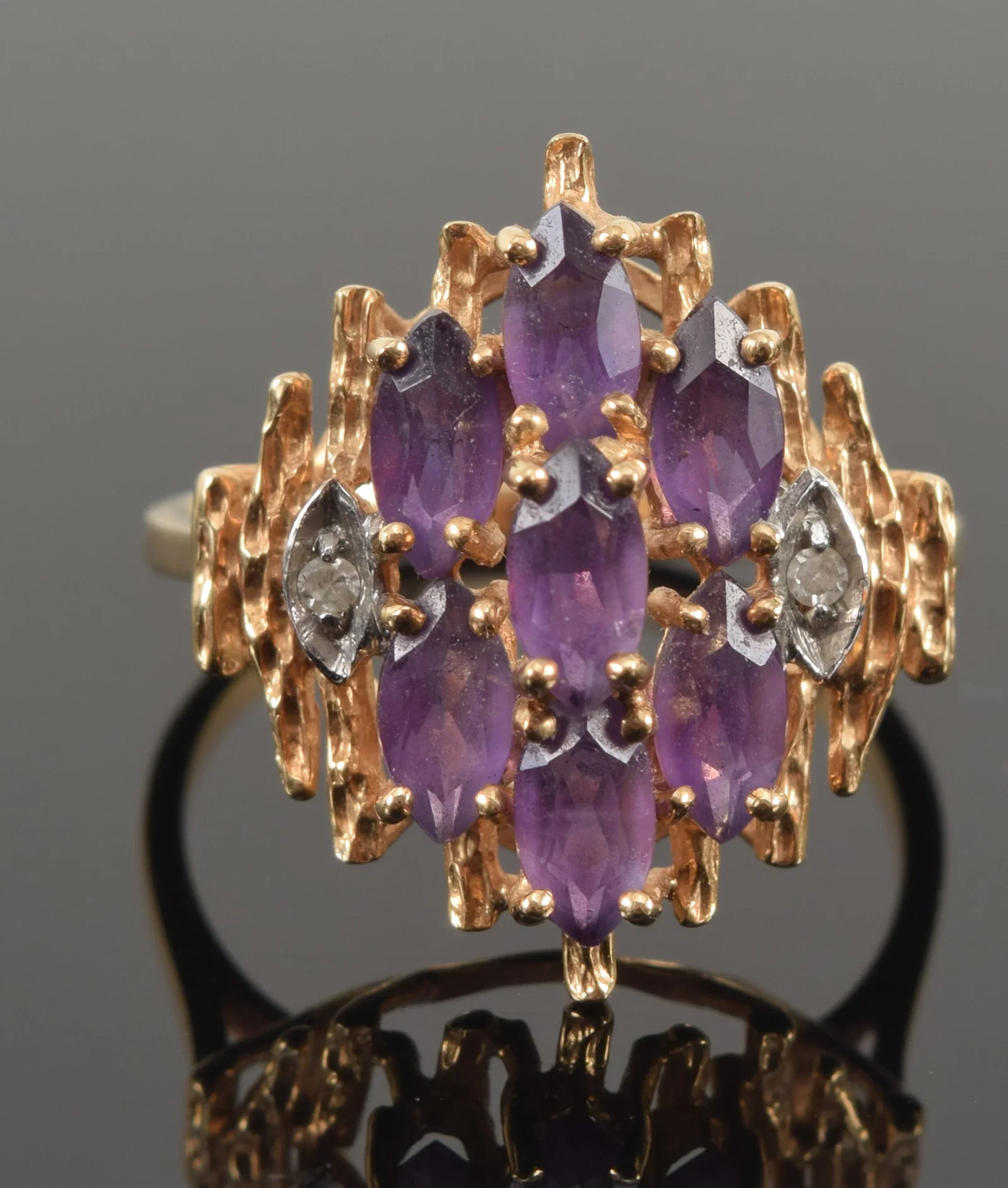 18K gold amethyst and diamond ring. Tiered open setting of amethysts