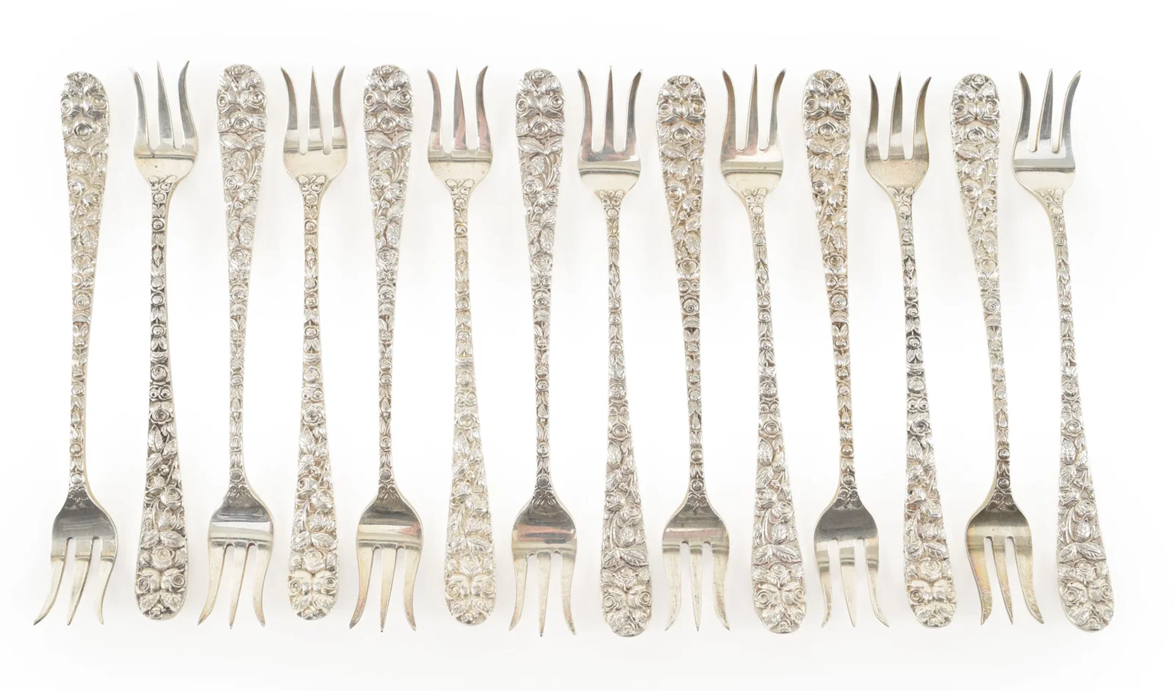 14 Sterling silver oyster forks with floral repousse pattern, one