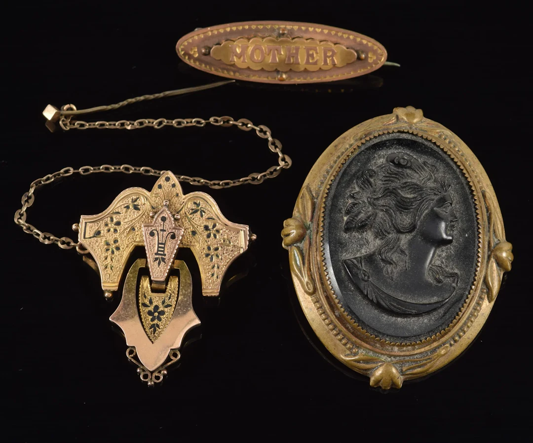 3 pieces of antique jewelry. 1) Large carved jet cameo brooch. 2 1/8in
