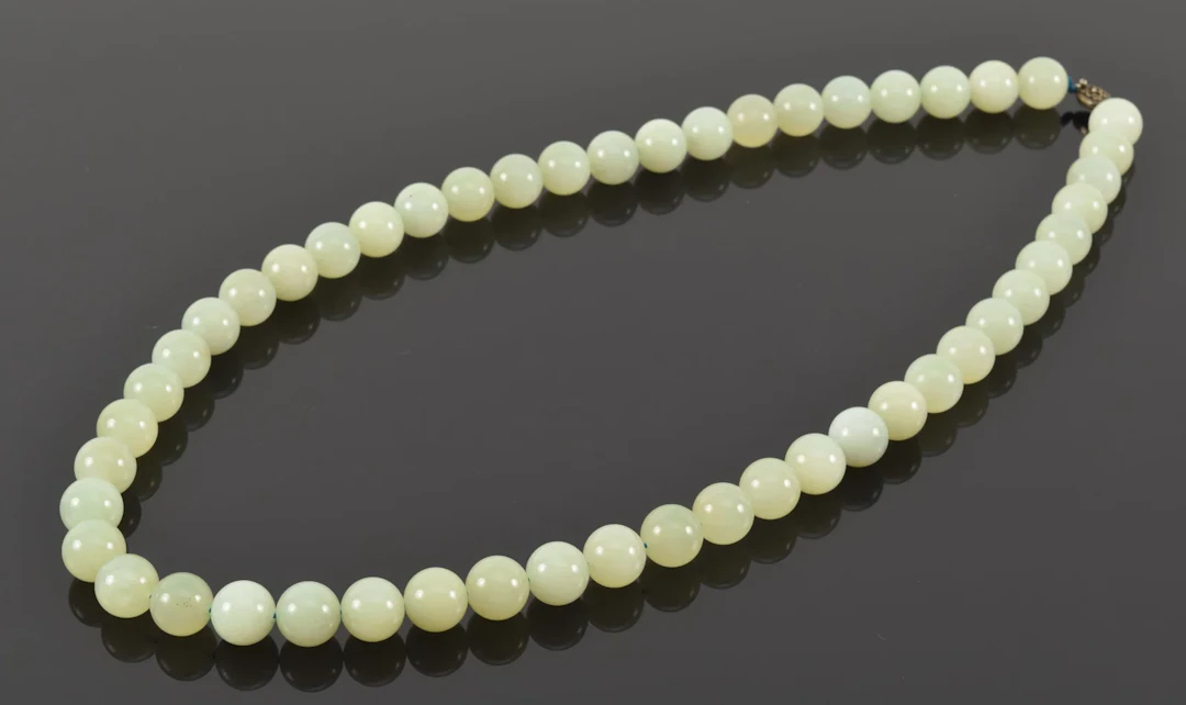 Silver clasped celadon jade bead necklace. Each bead approx. 5/8in