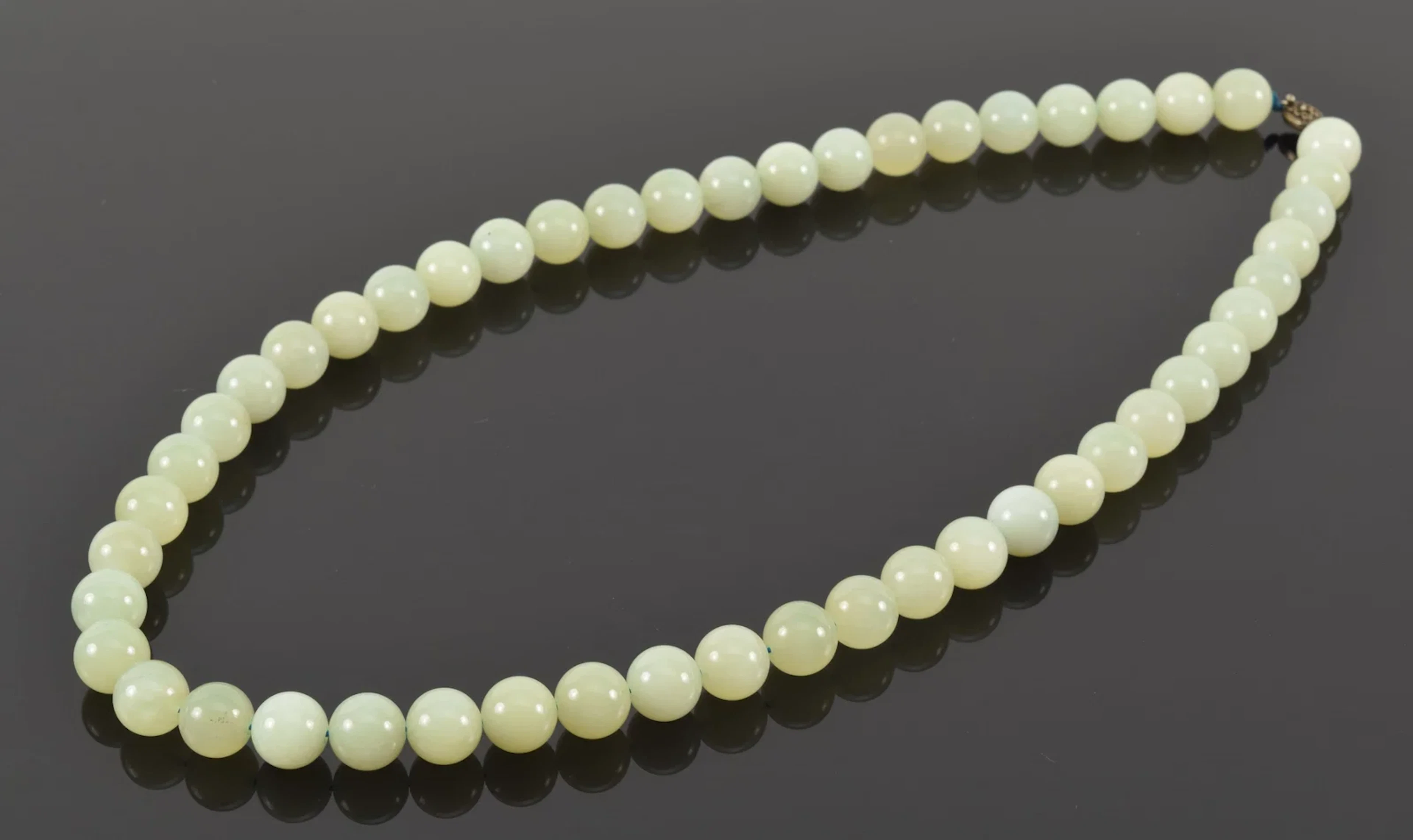 Silver clasped celadon jade bead necklace. Each bead approx. 5/8in