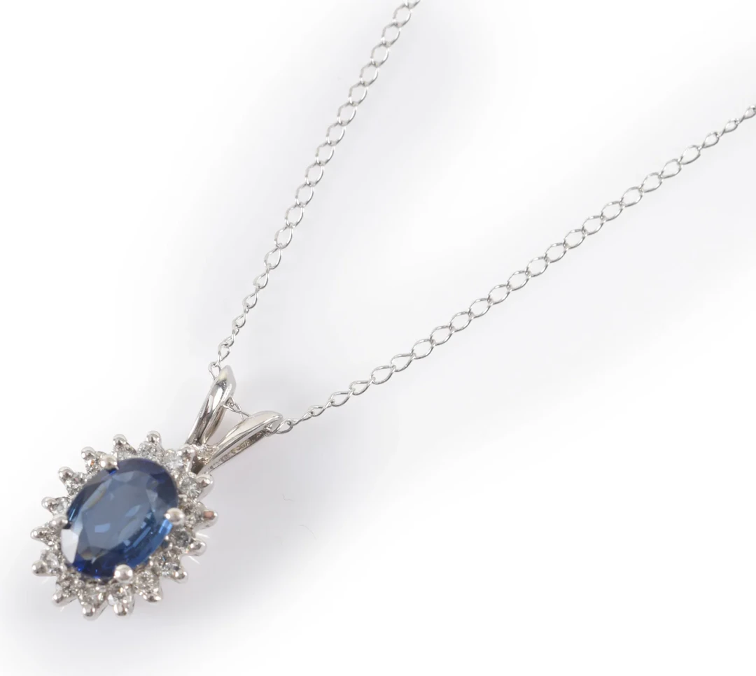 14K white gold sapphire and diamond pendant necklace. Oval cut sapphire