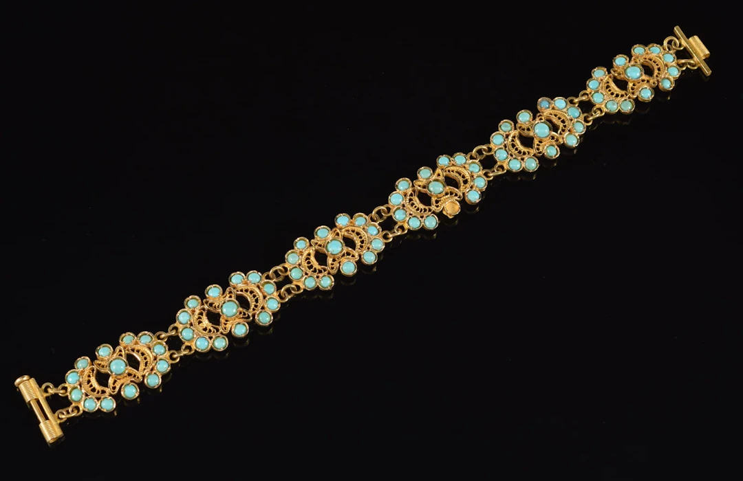 14K gold bracelet mounted with turquoise cabochons. One turquoise
