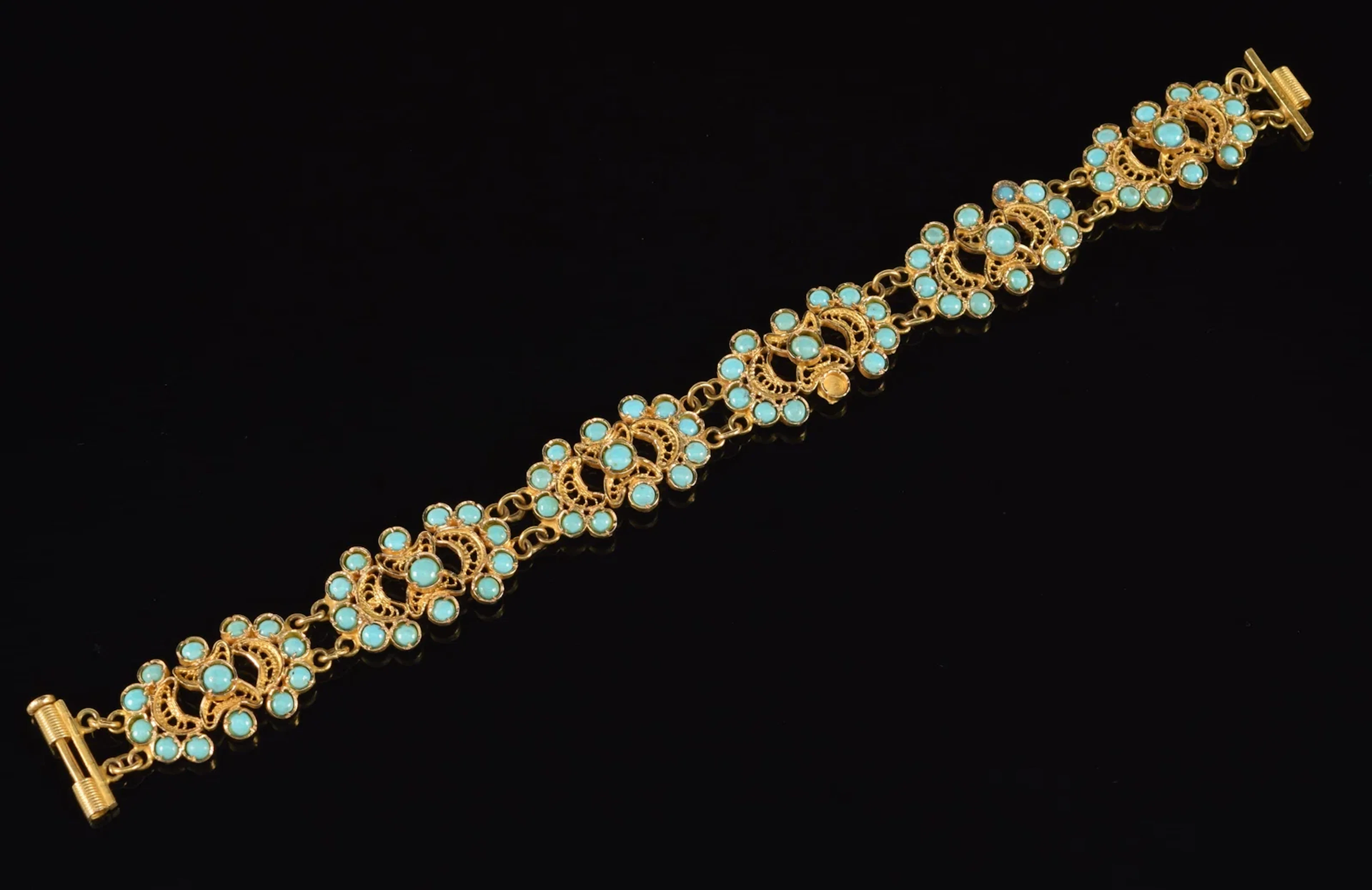 14K gold bracelet mounted with turquoise cabochons. One turquoise