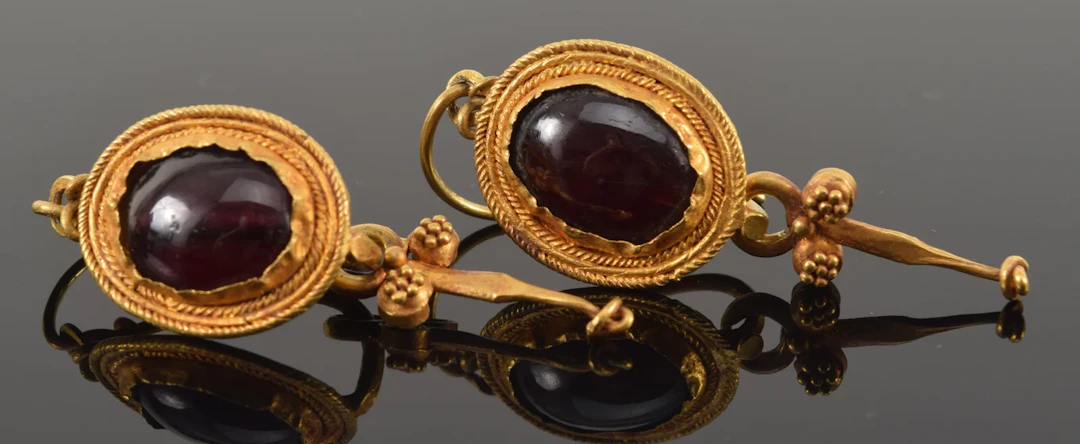 Antique 18K gold garnet earrings. Oval garnet stones in braided gold