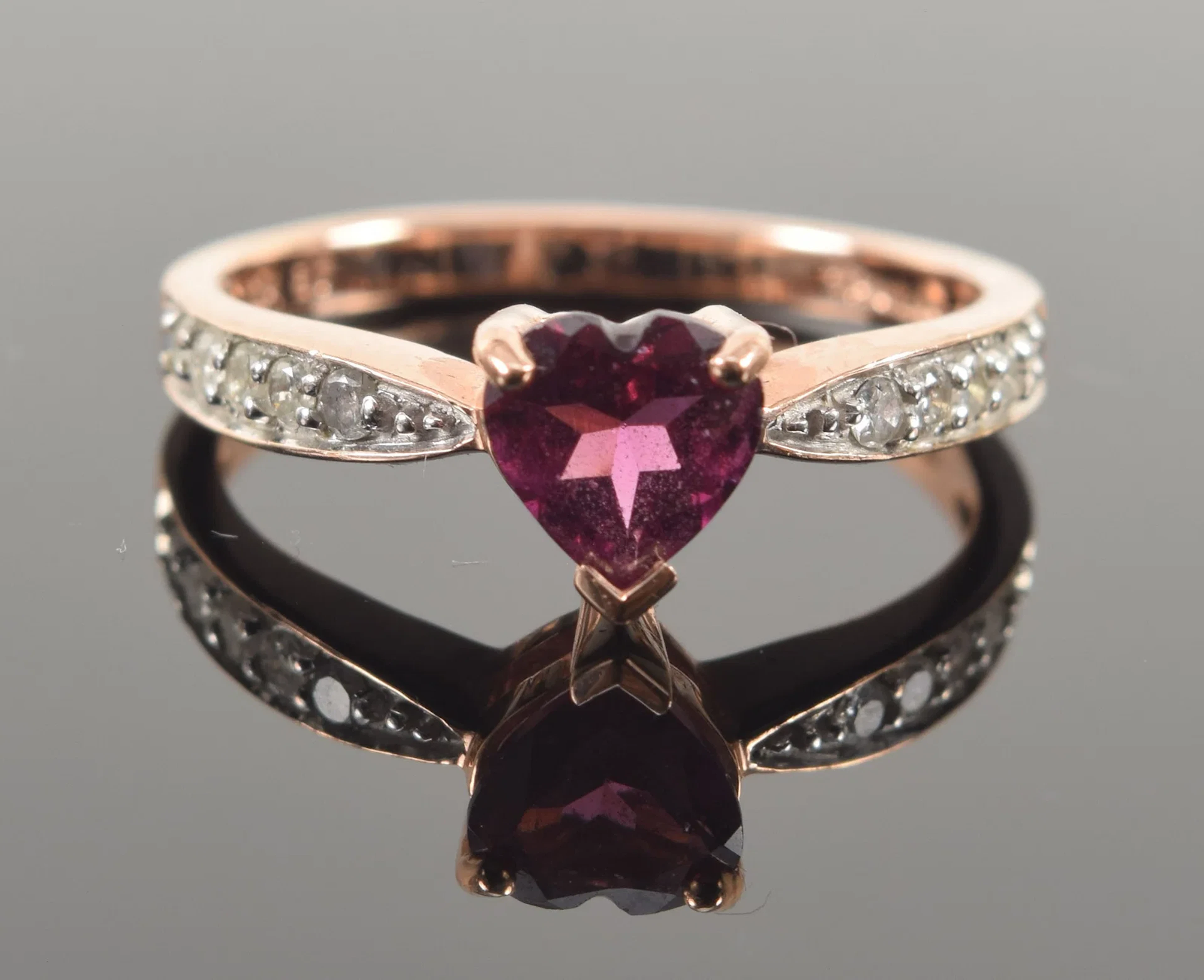 10K rose gold heart shaped garnet ring. Shanks with small round cut