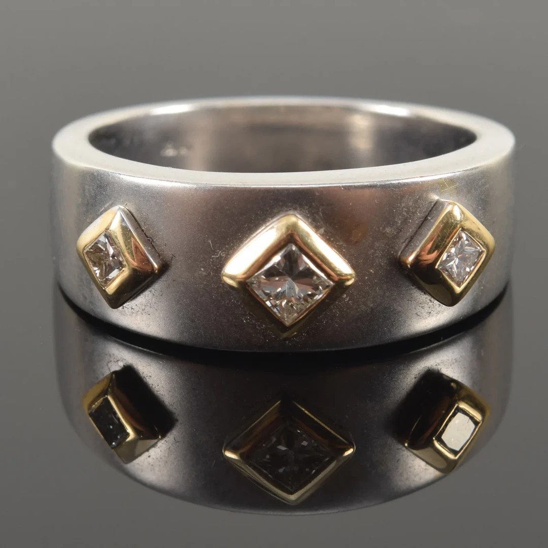14K white and yellow gold diamond ring. 3 square cut diamonds surrounded