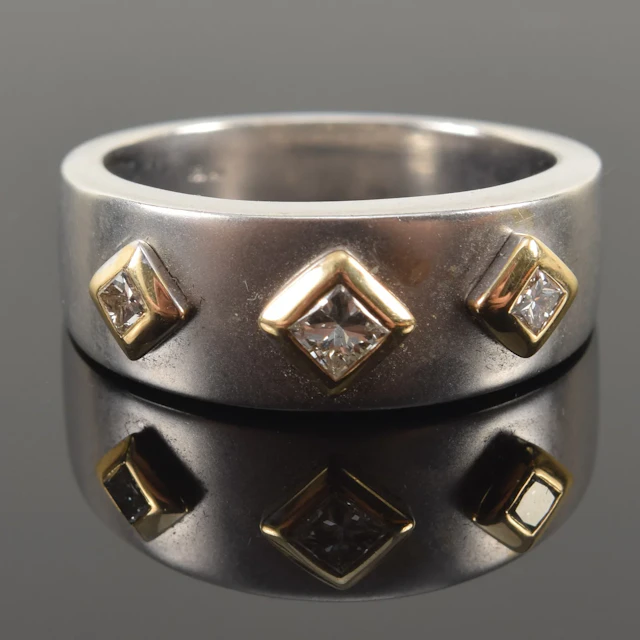 14K white and yellow gold diamond ring. 3 square cut diamonds surrounded