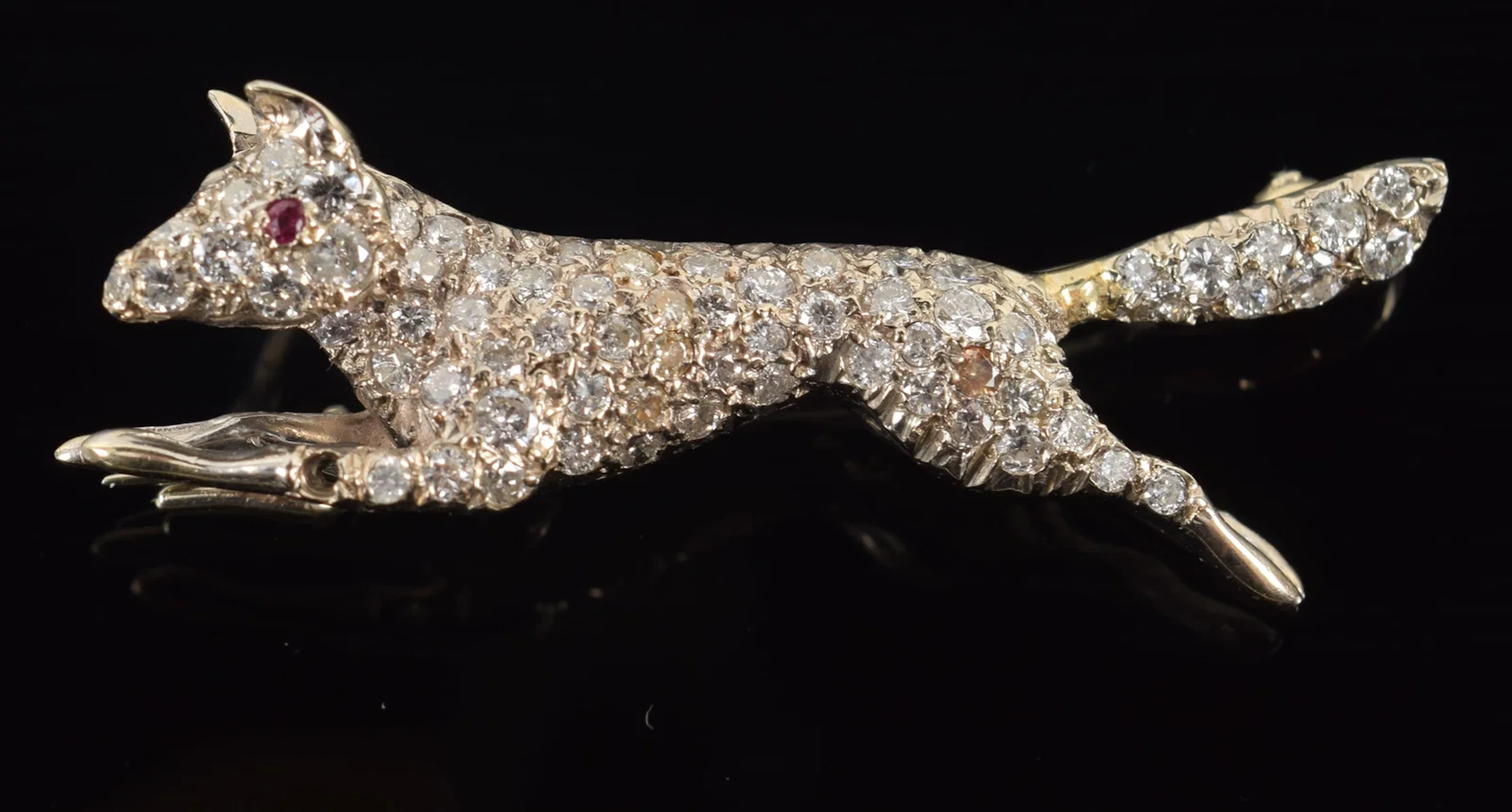 14K white gold fox form diamond pave pin. Ruby set eye. One diamond