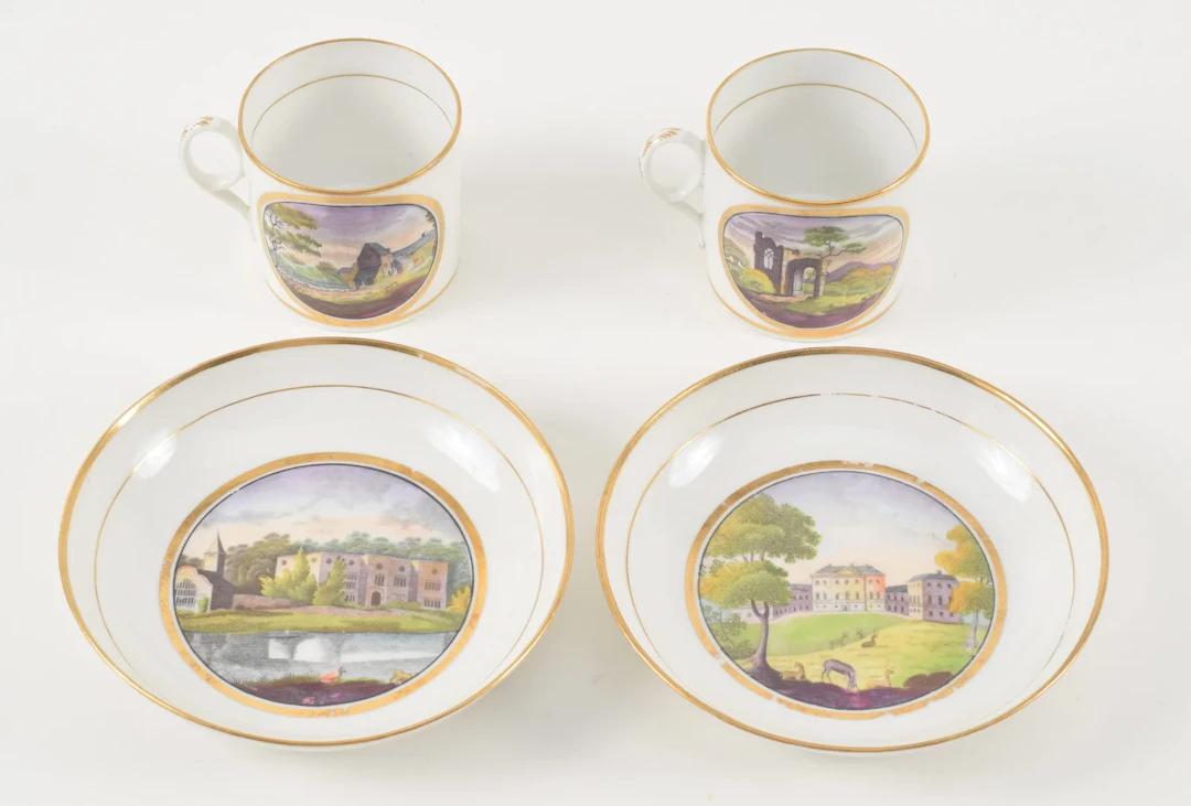 Pair of English porcelain cups and saucers, early/mid 19th century.