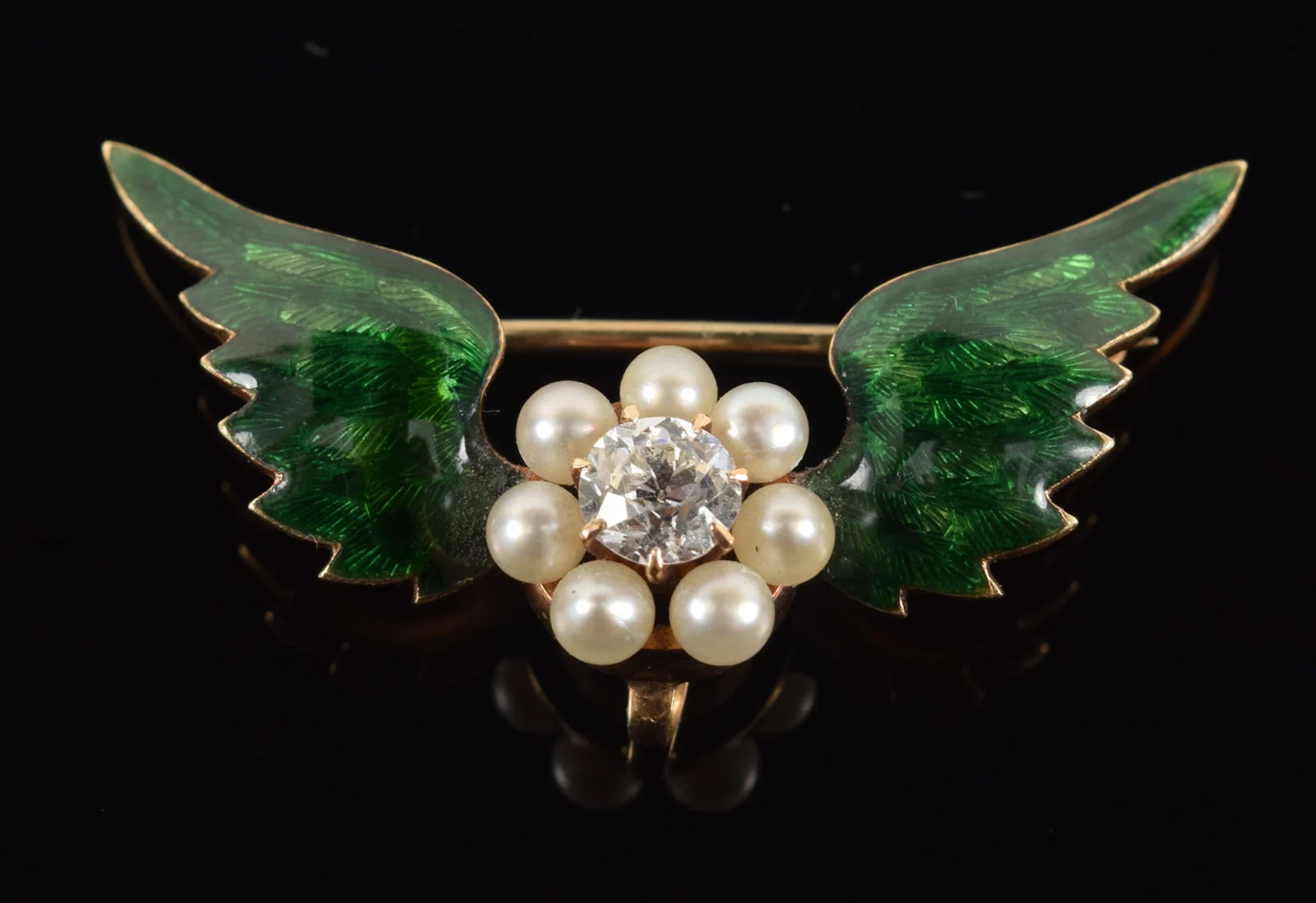 14K gold enamel decorated winged pin. Central round cut diamond (about
