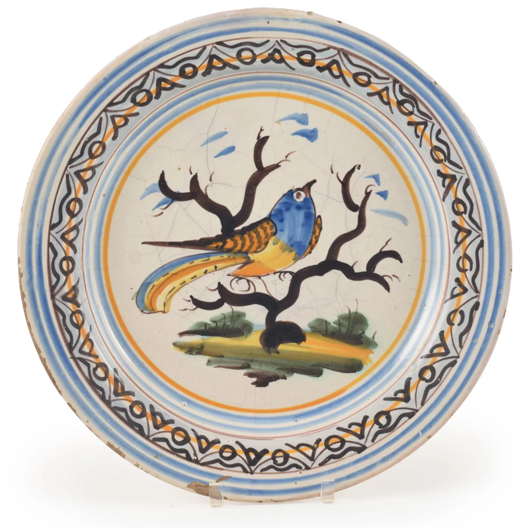 Antique majolica polychrome glazed charger with large bird on a branch