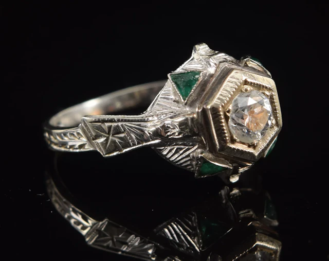 Antique 20K white gold diamond and emerald ring. Raised bright cut