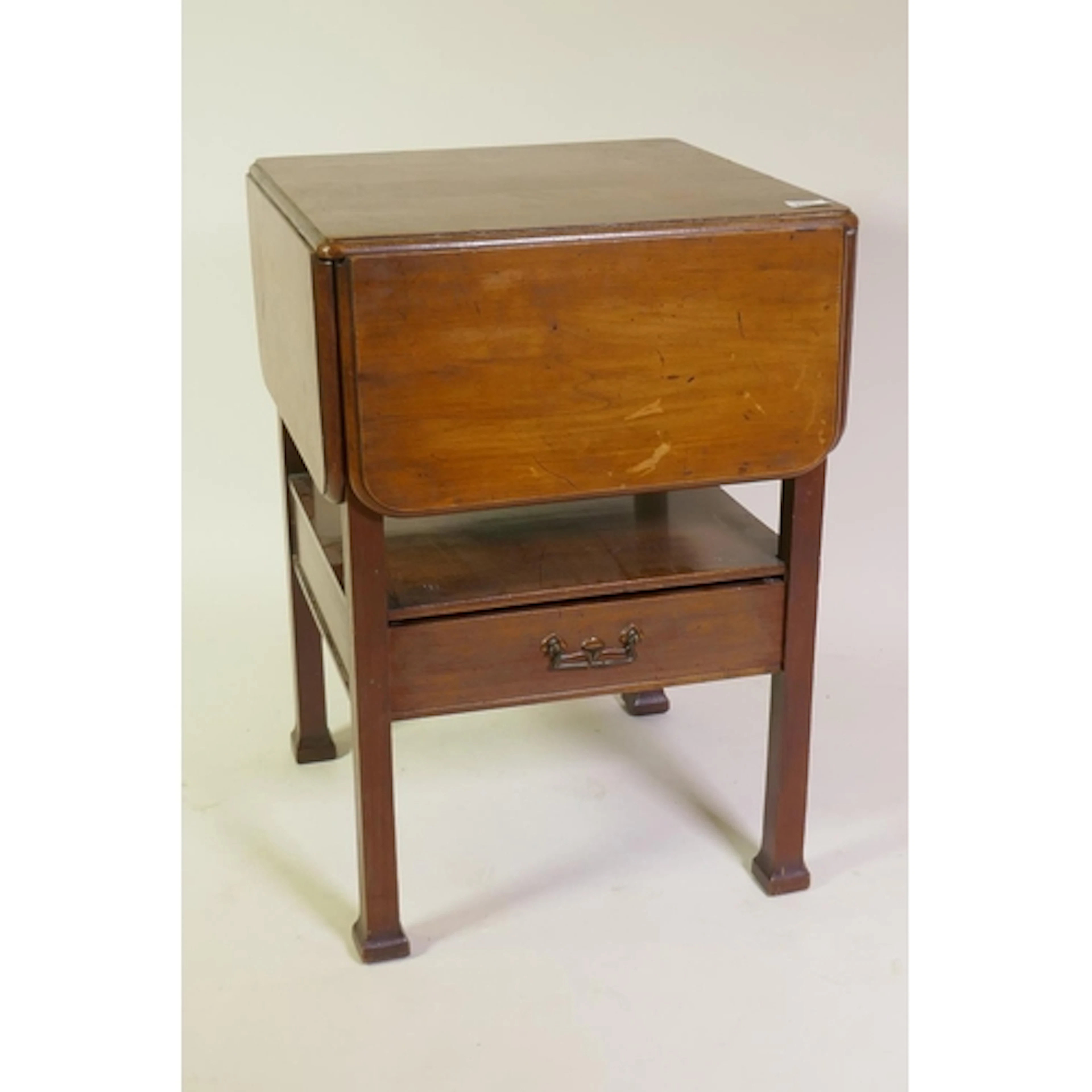 A late C19th mahogany occasional table with four flaps and s...