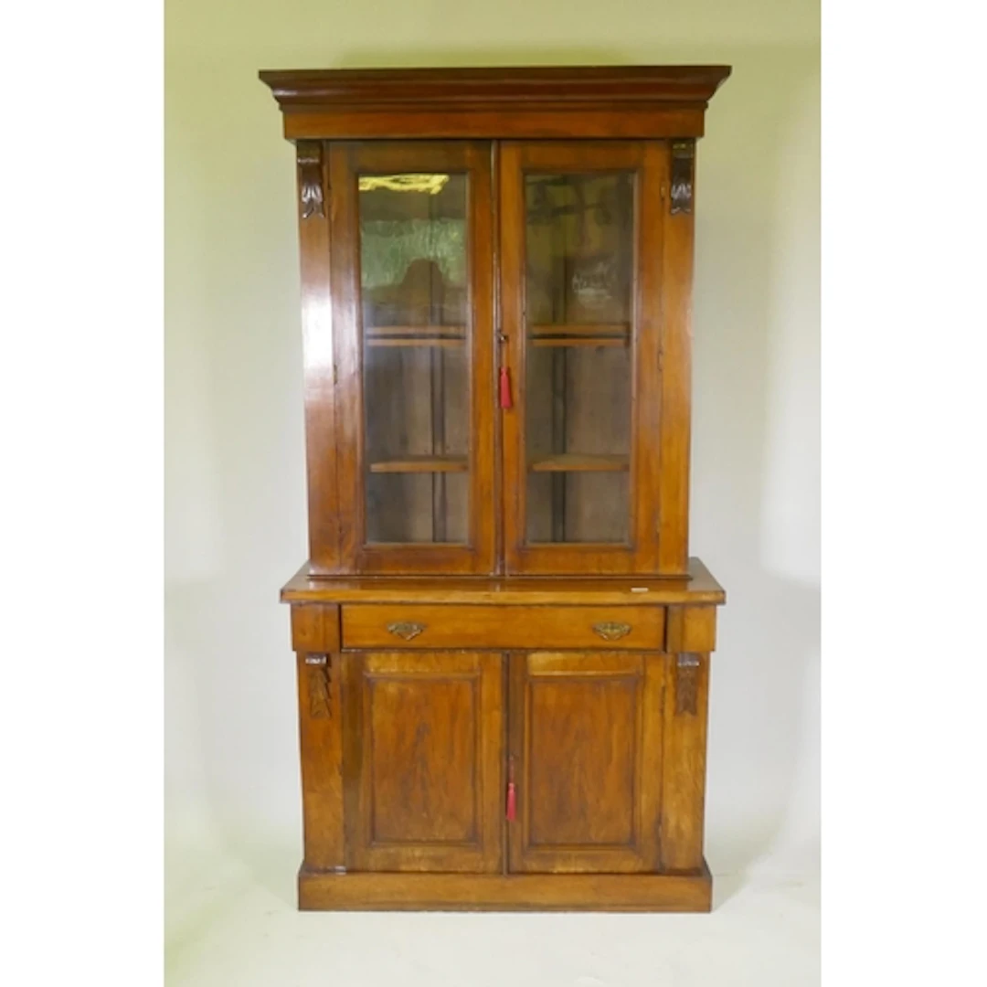 A Victorian rosewood bookcase in two sections, the upper wit...