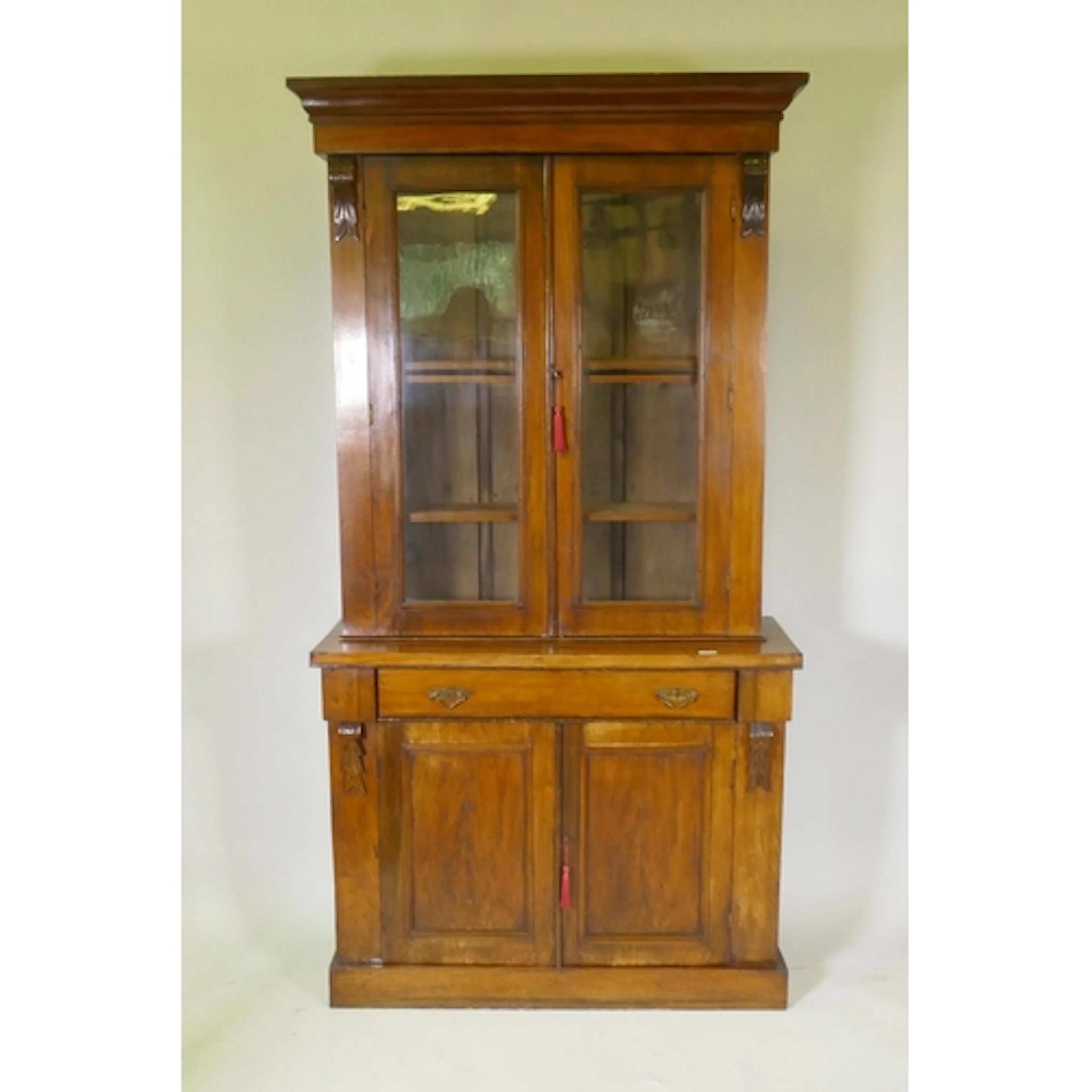 A Victorian rosewood bookcase in two sections, the upper wit...