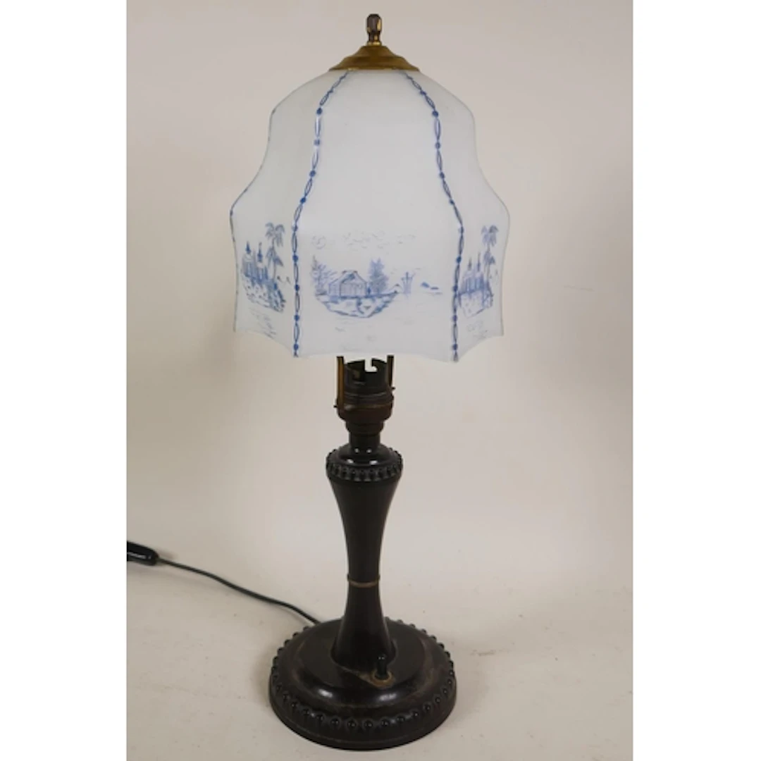 A 1920s Bakelite table lamp with original glass shade decora...