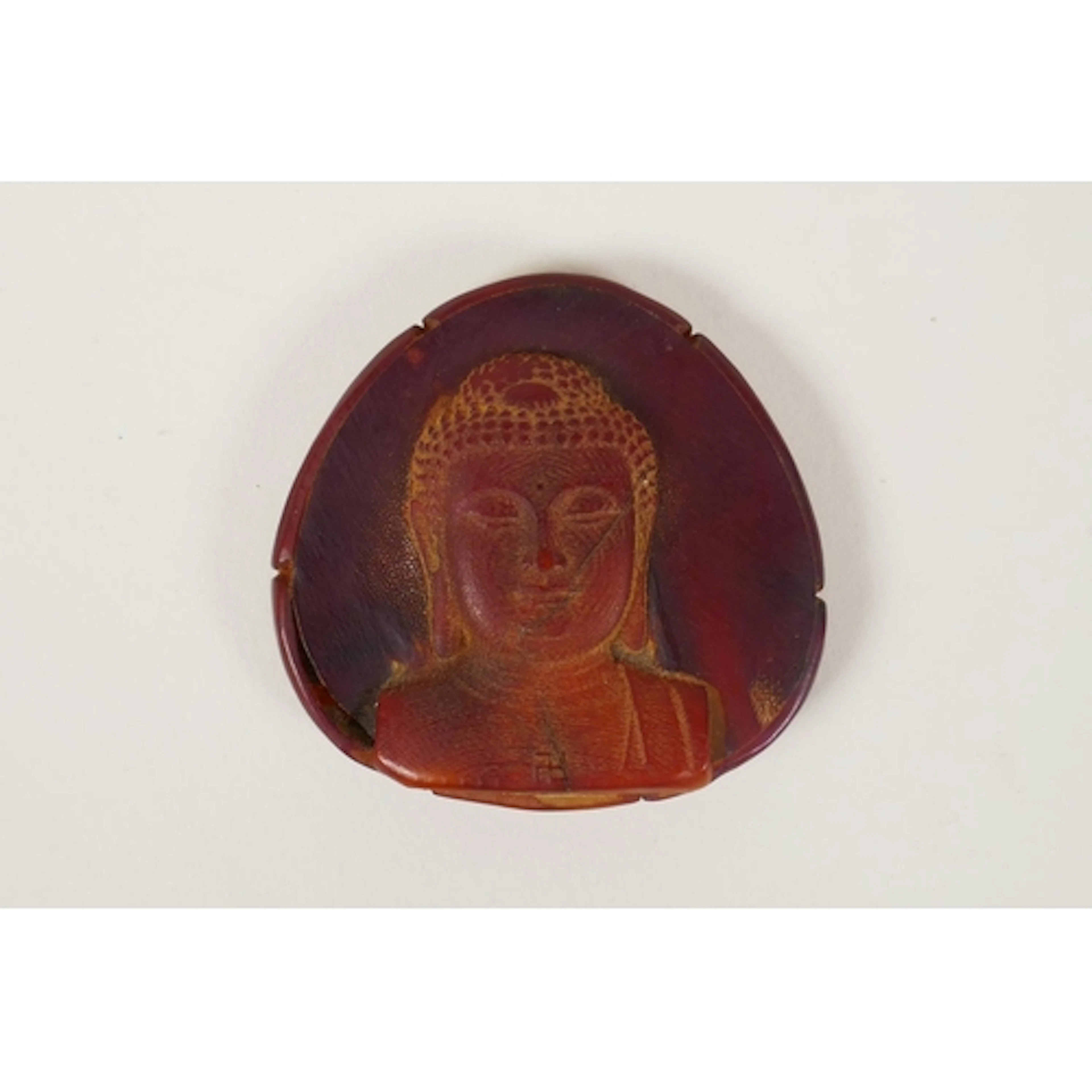A Chinese sectional horn pendant with Buddha head decoration...