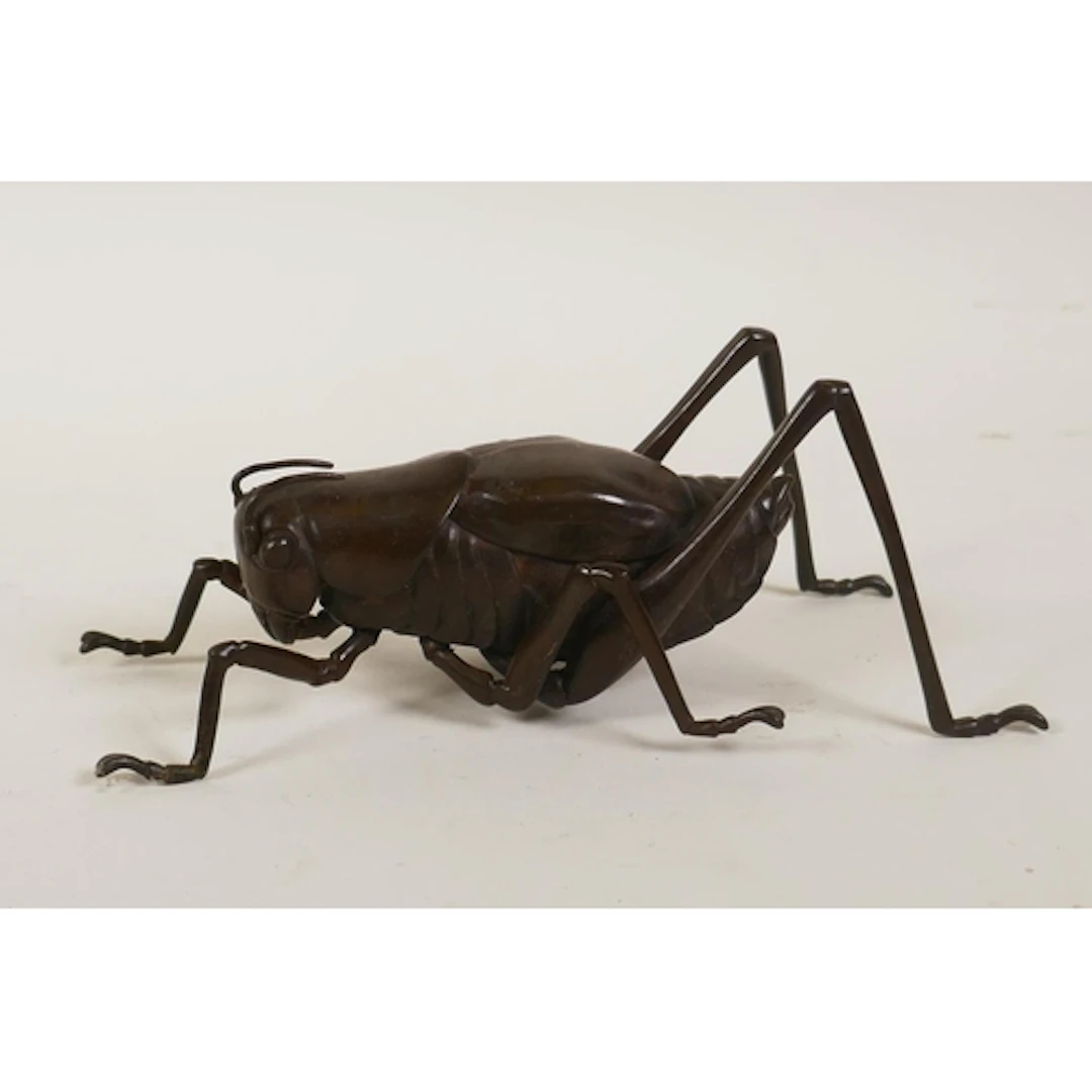 A Japanese style bronze okimono cricket, 17cm long