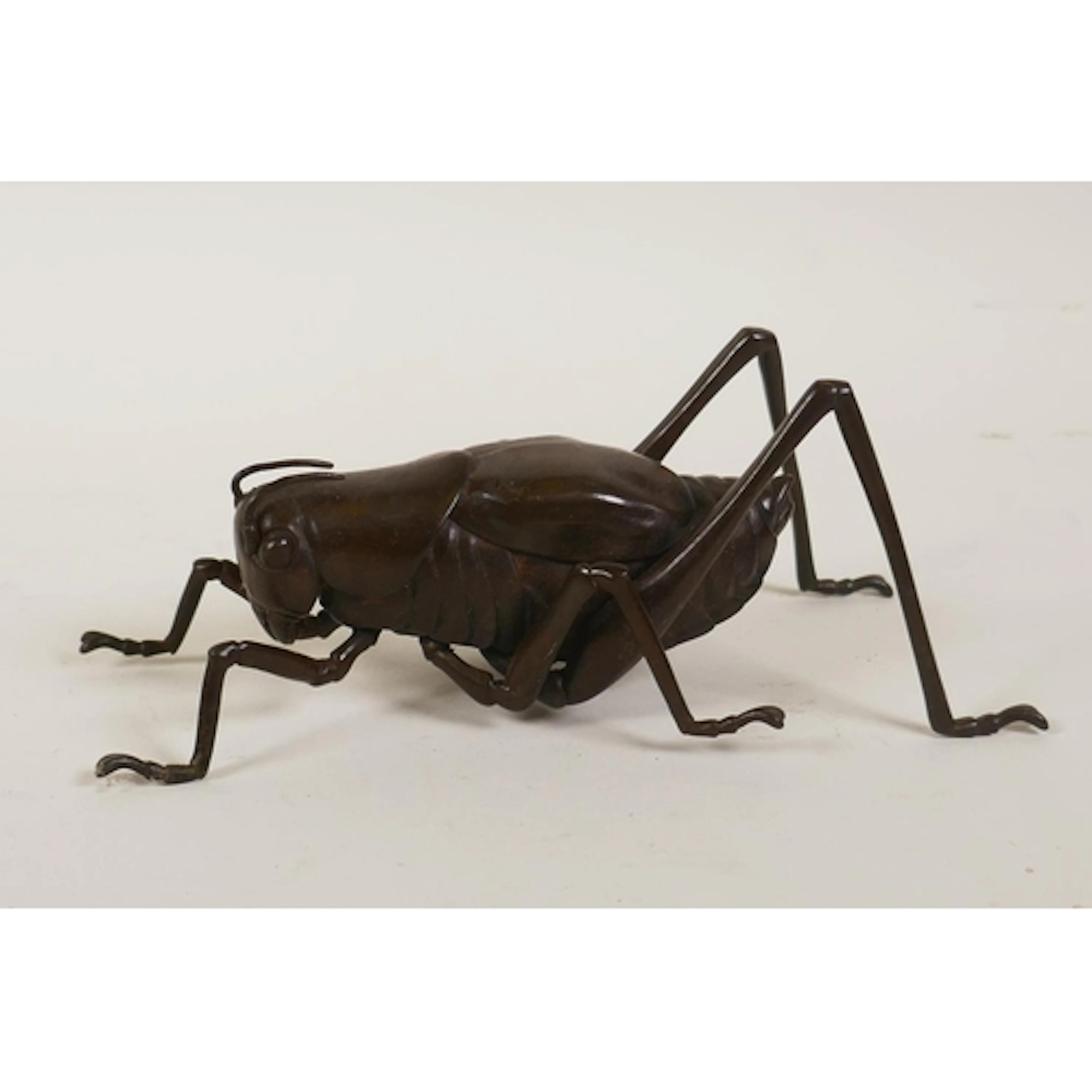 A Japanese style bronze okimono cricket, 17cm long