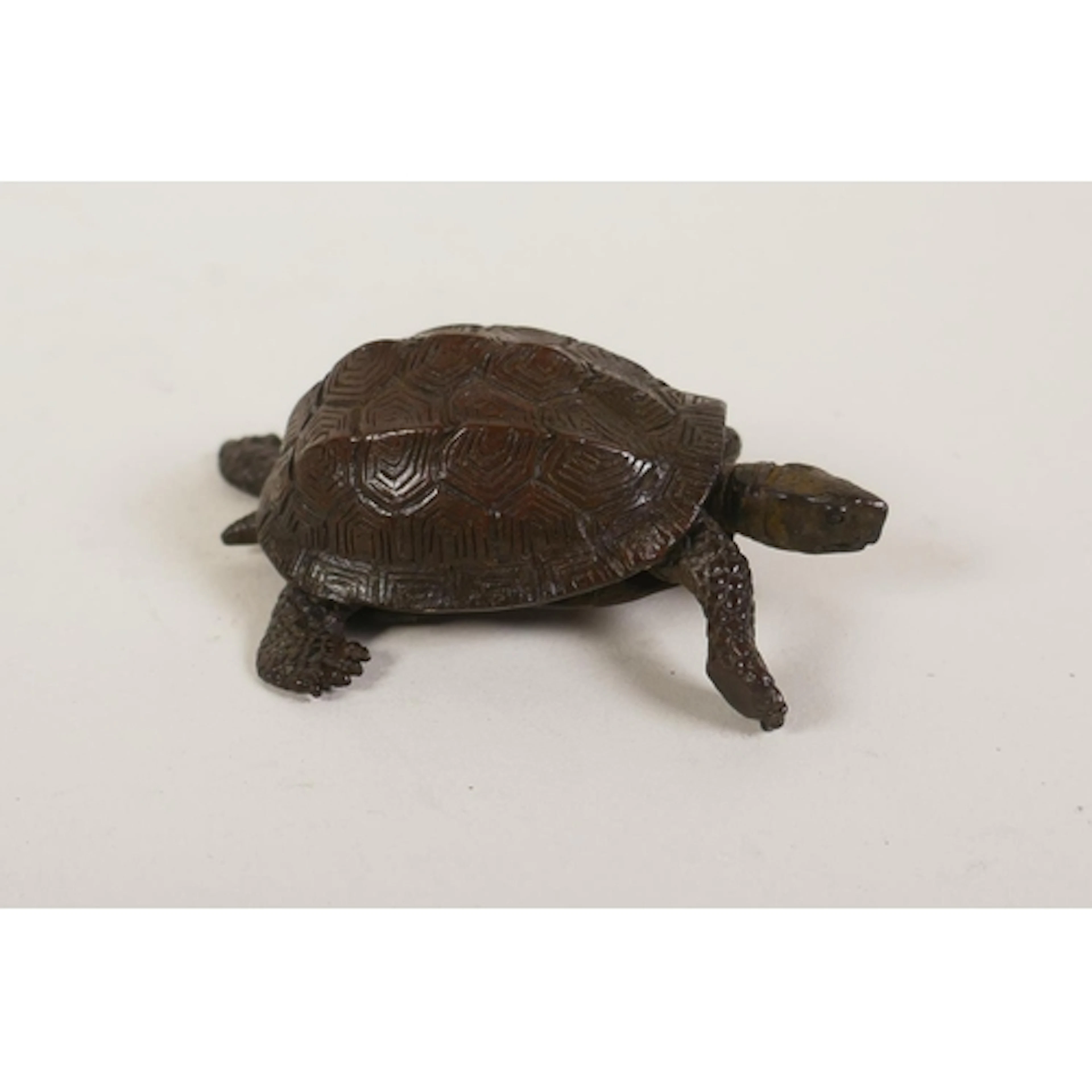A miniature bronzed metal tortoise with articulated limbs, i...