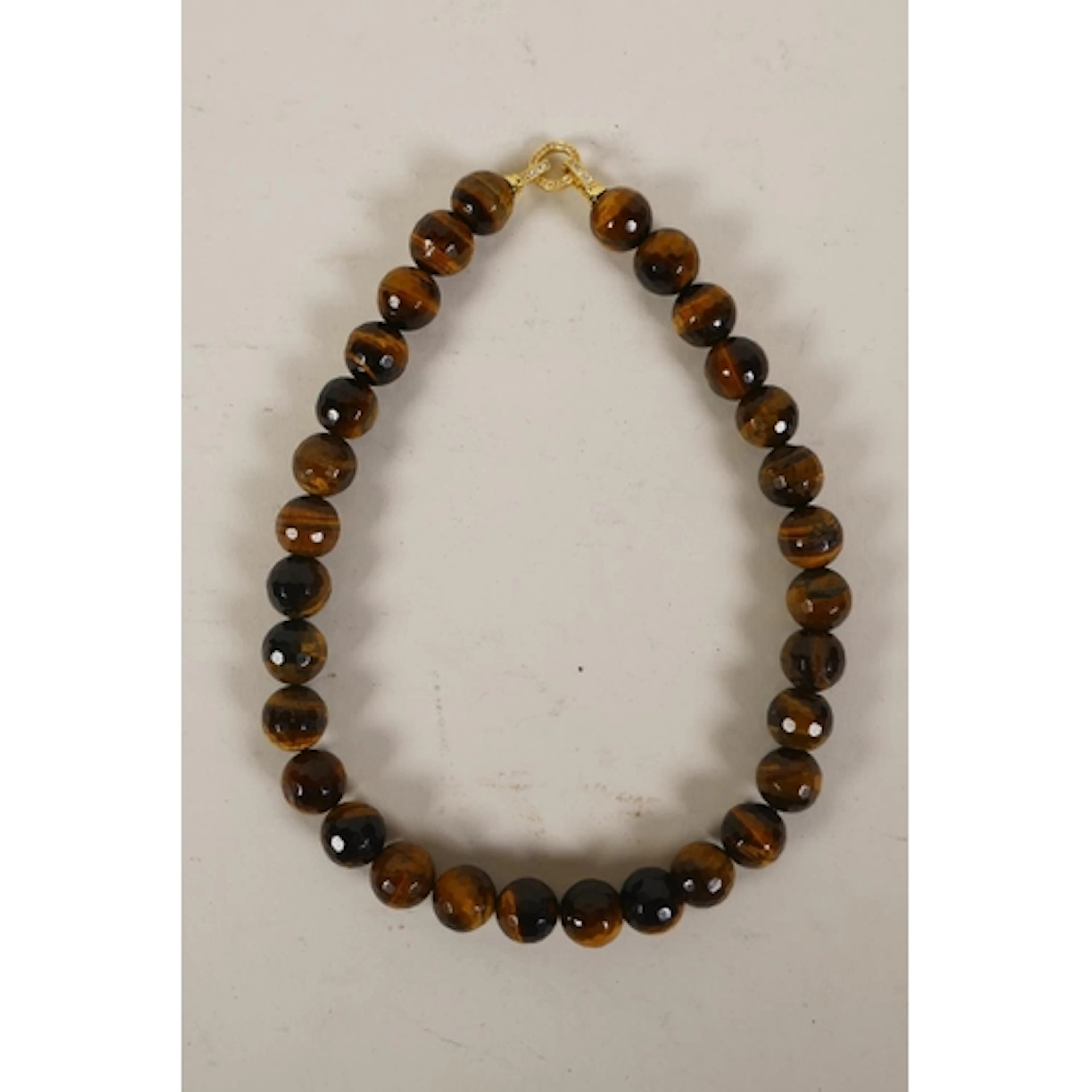 A faceted tiger's eye beaded necklace with cubic zirconia se...