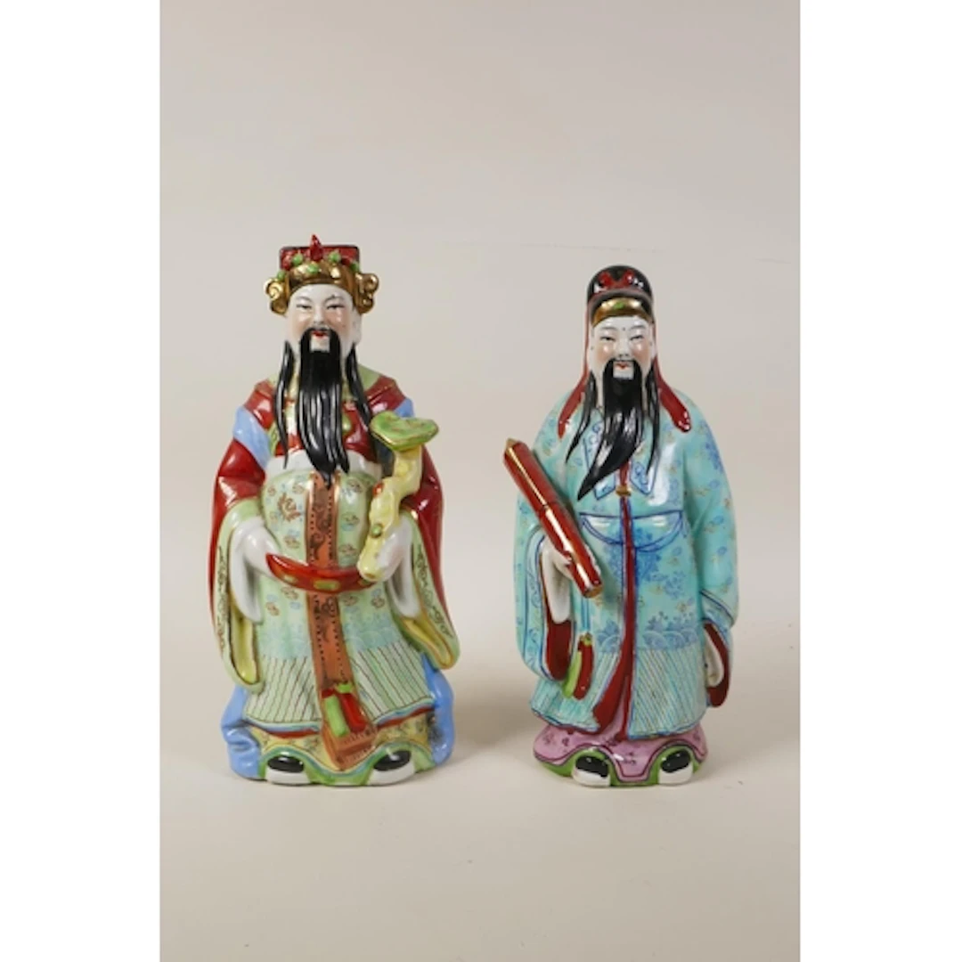 A pair of Chinese polychrome porcelain figures of Fu and Lu,...