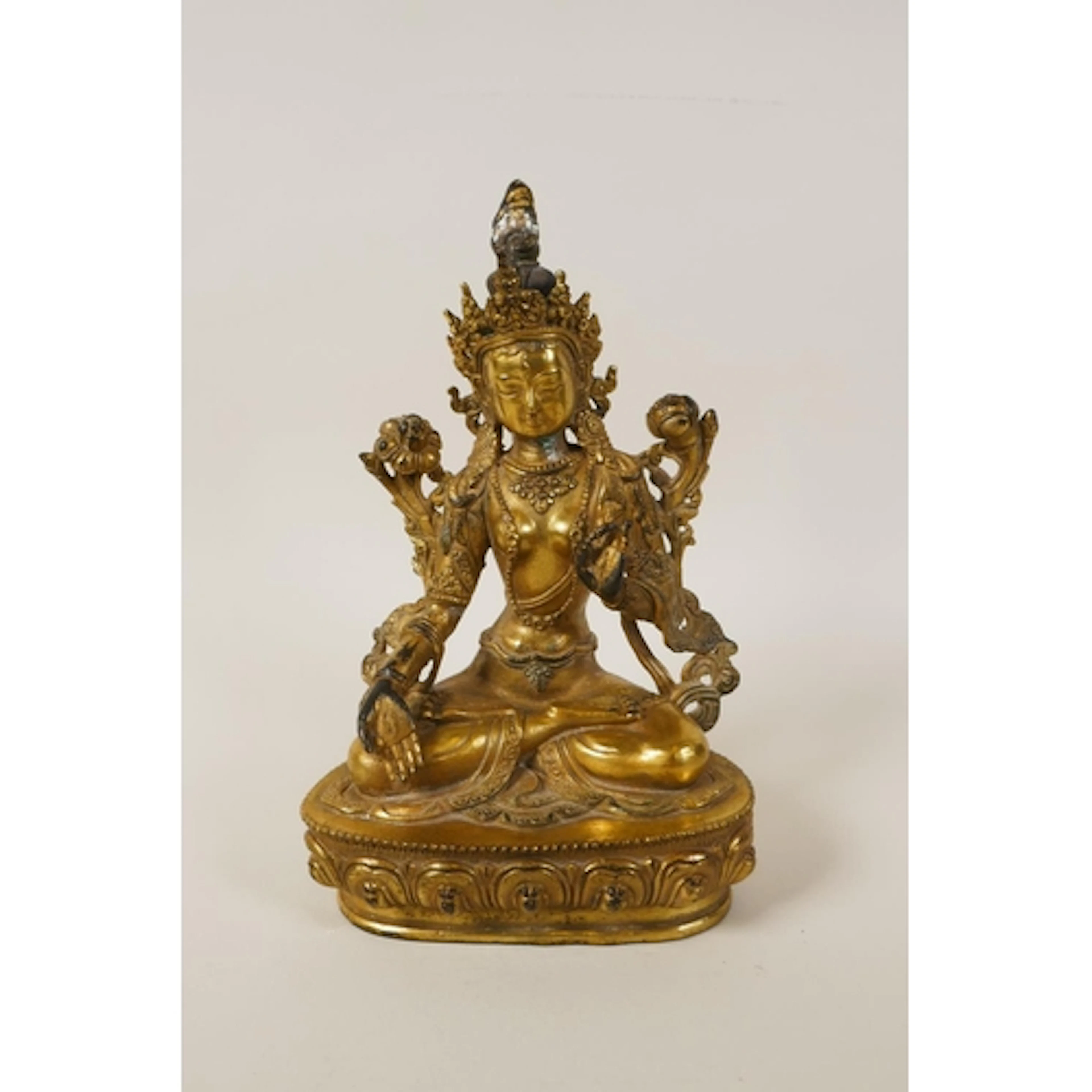 A Tibetan filled gilt bronze Green Tara, double vajra mark t...