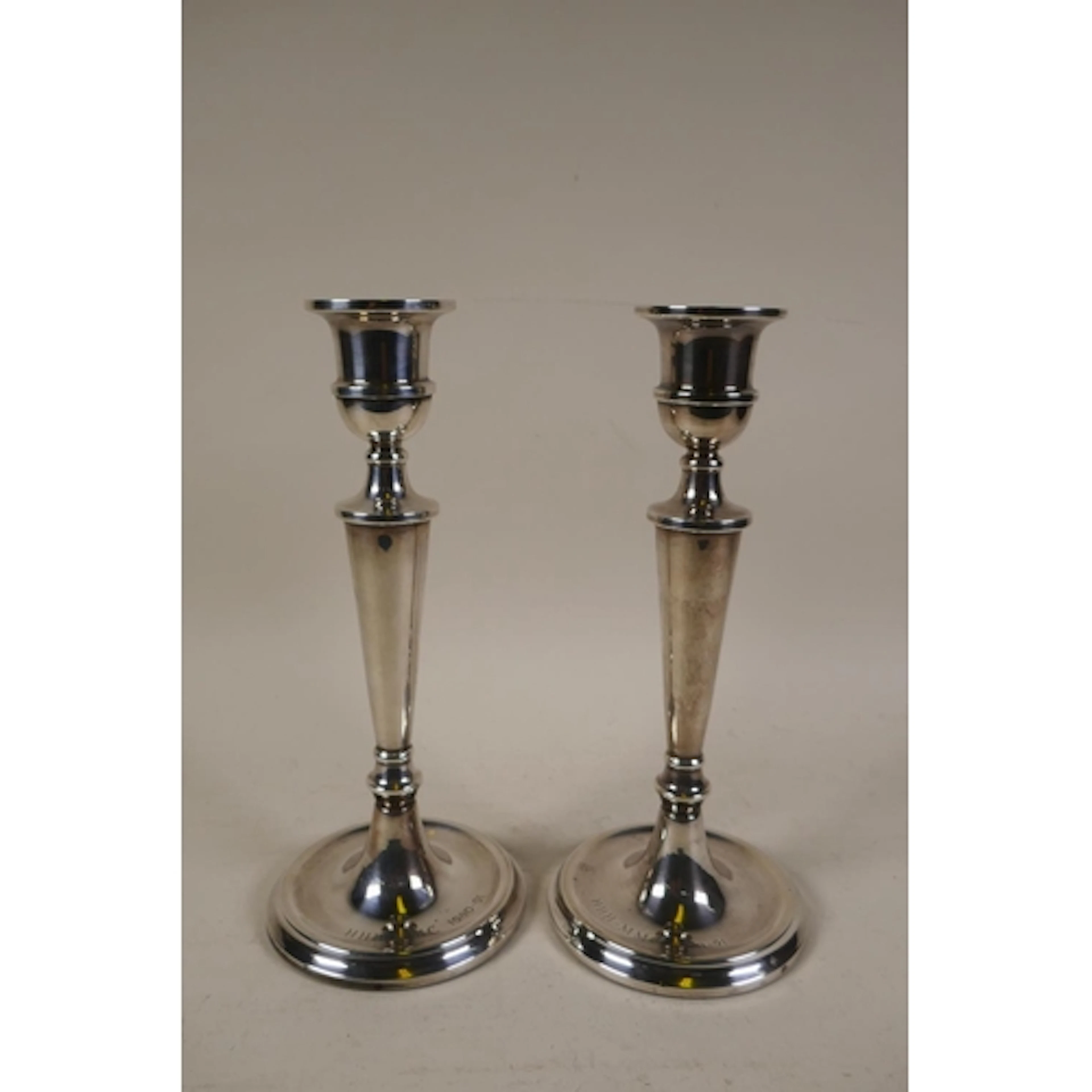 A pair of silver candlesticks by W.I. Broadway & Co, Bir...