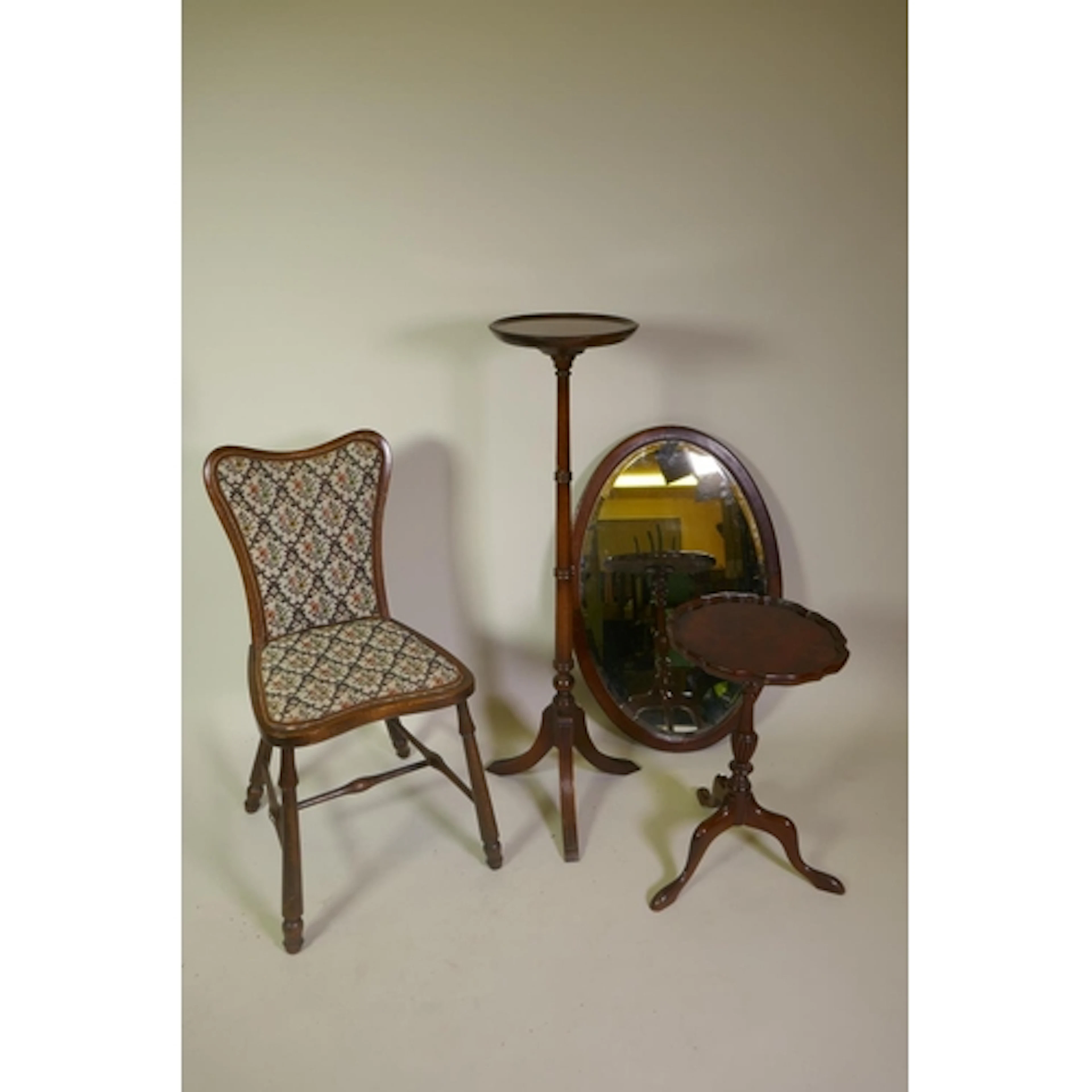 A mahogany turned wood jardiniere stand on fluted tripod sup...