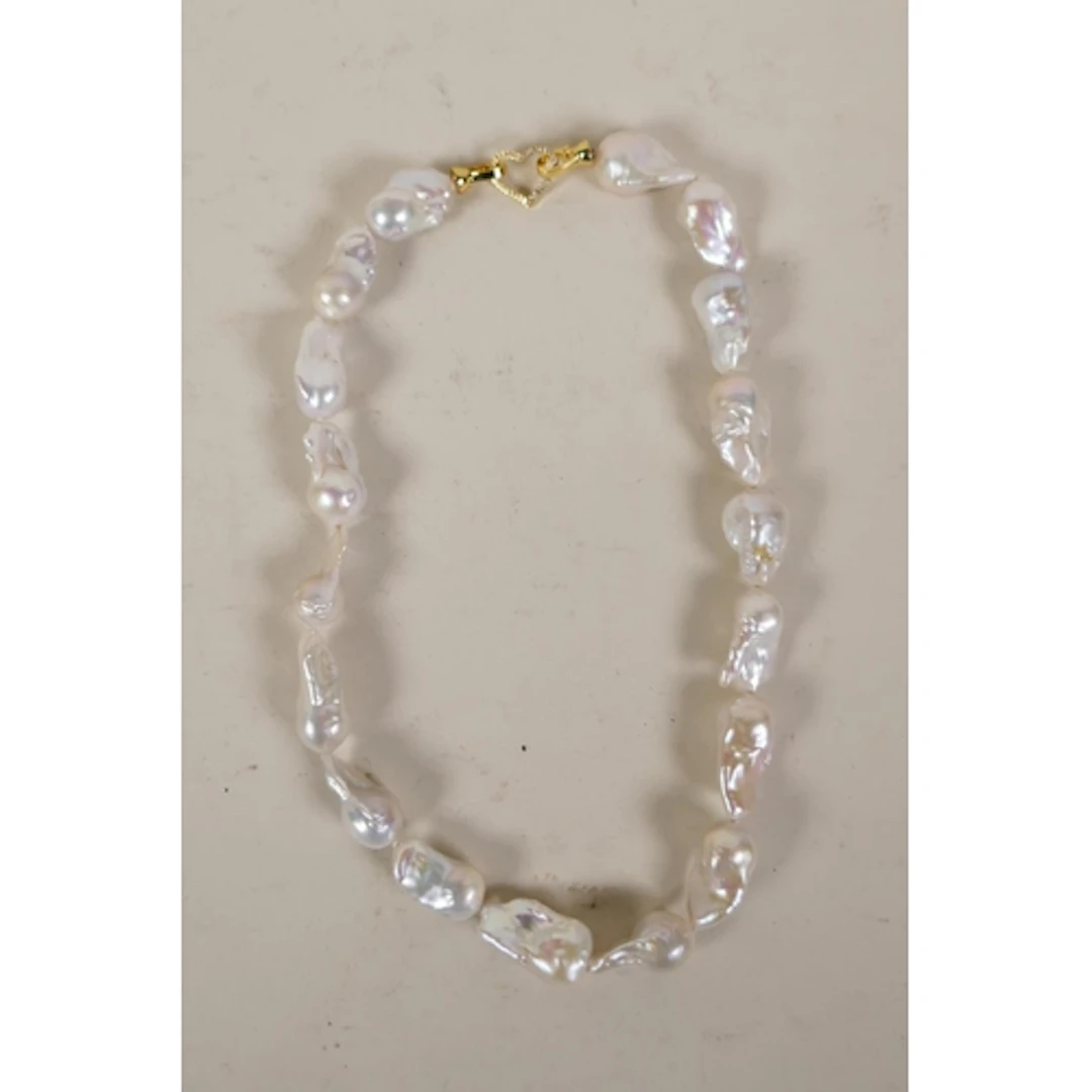A large natural fresh water baroque pearl necklace with a cu...
