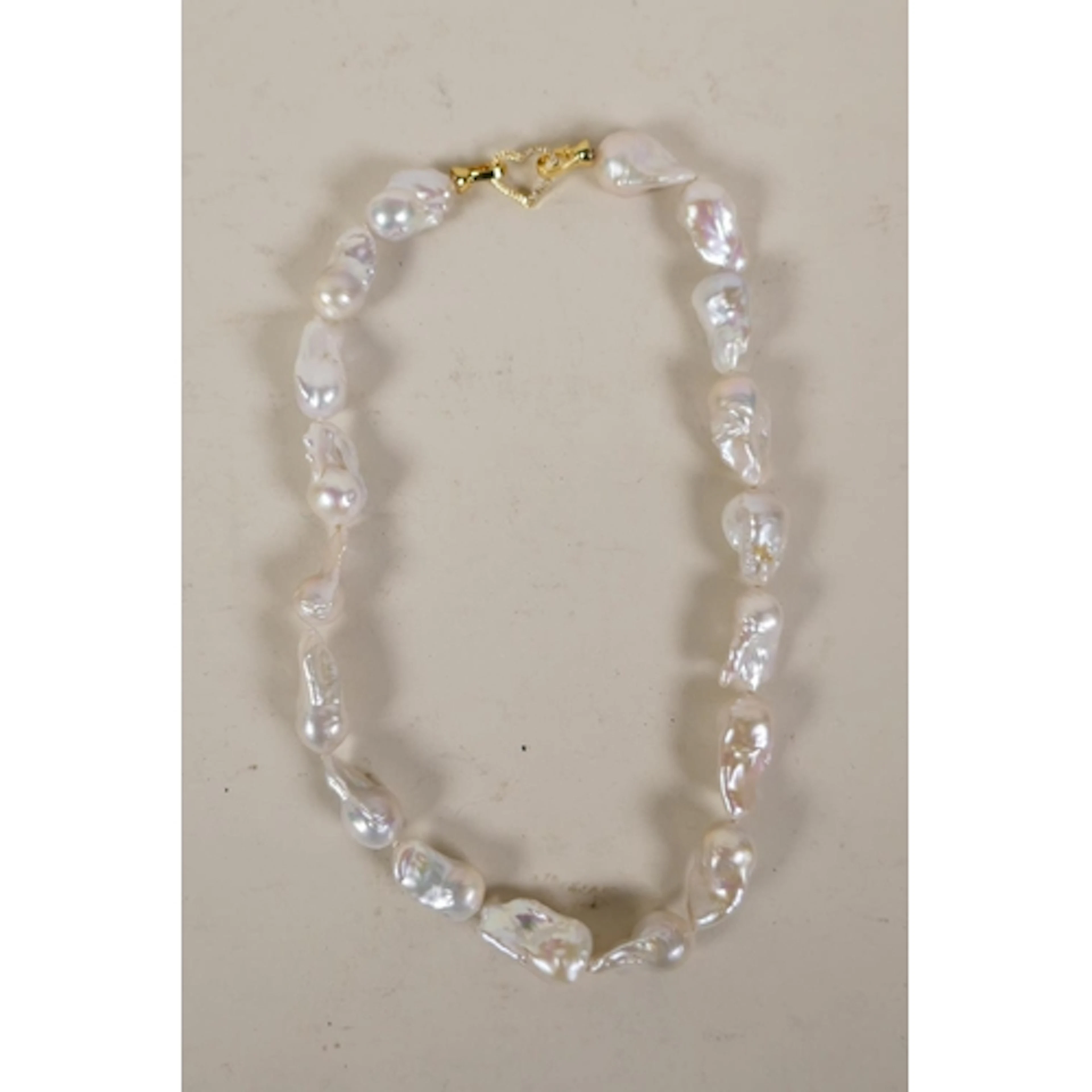 A large natural fresh water baroque pearl necklace with a cu...