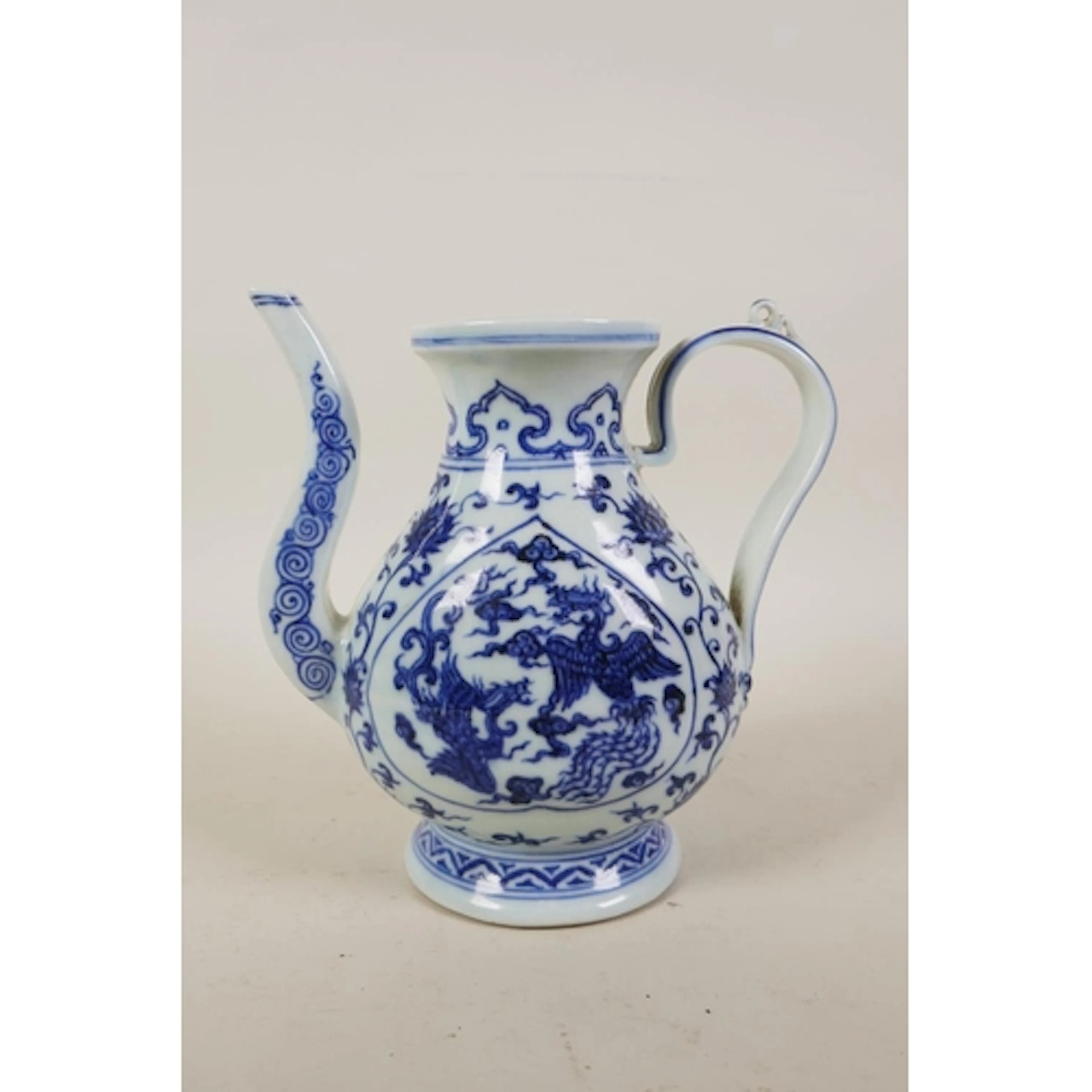 A Chinese blue and white porcelain ewer with phoenix and lot...