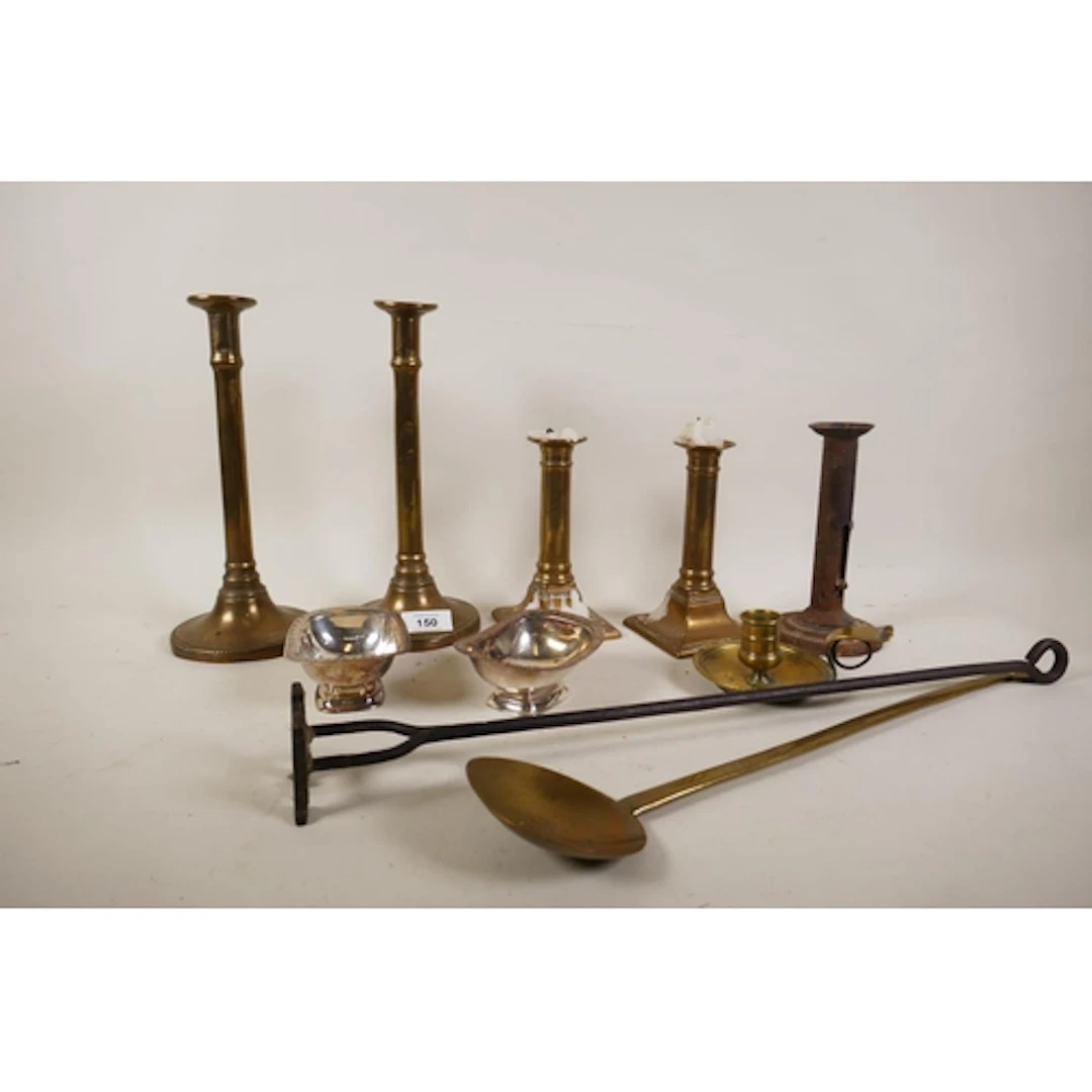 A collection of C18th and C19th brass chambersticks and cand...