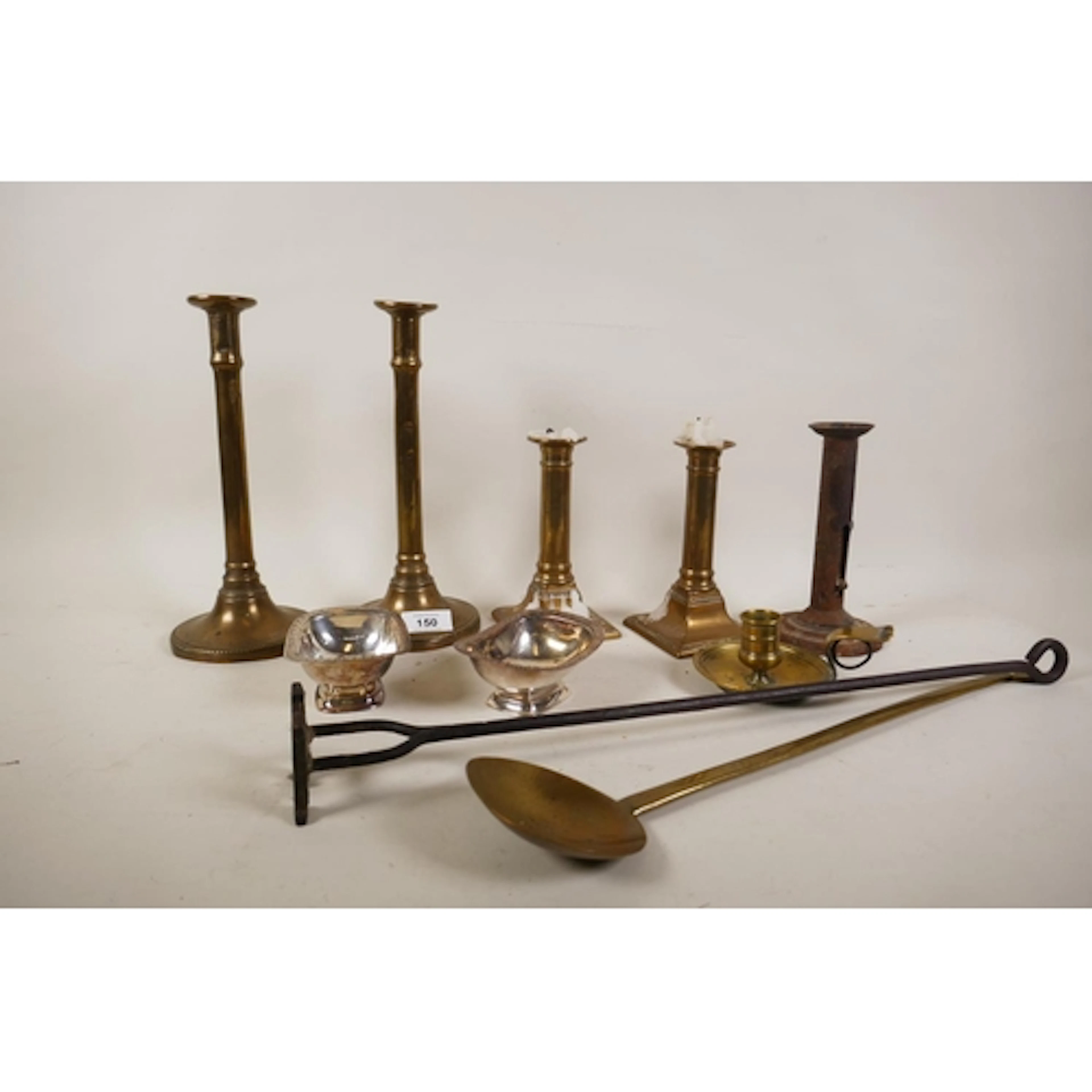 A collection of C18th and C19th brass chambersticks and cand...