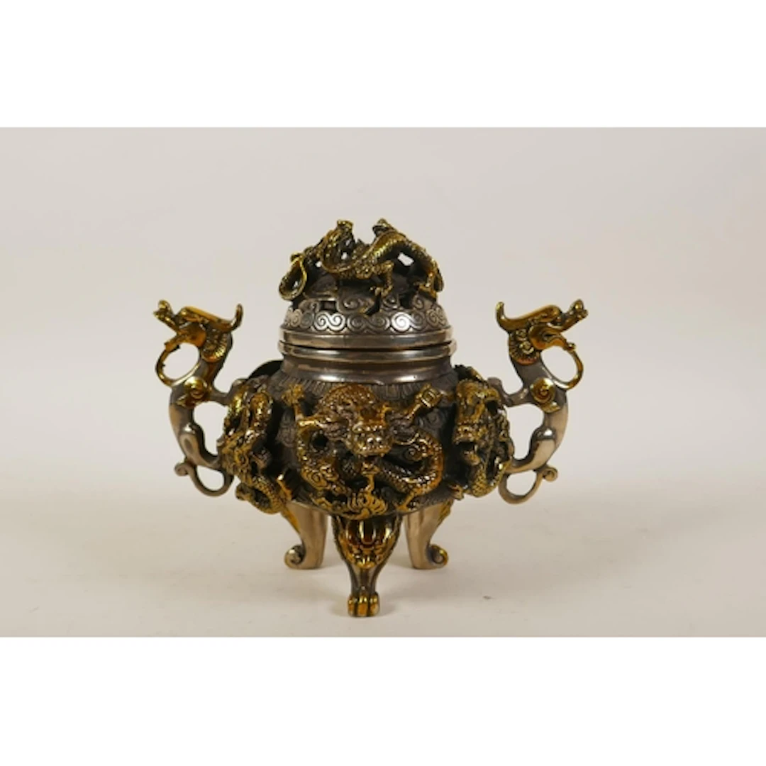 A Chinese silvered metal censer and cover with gilt highligh...
