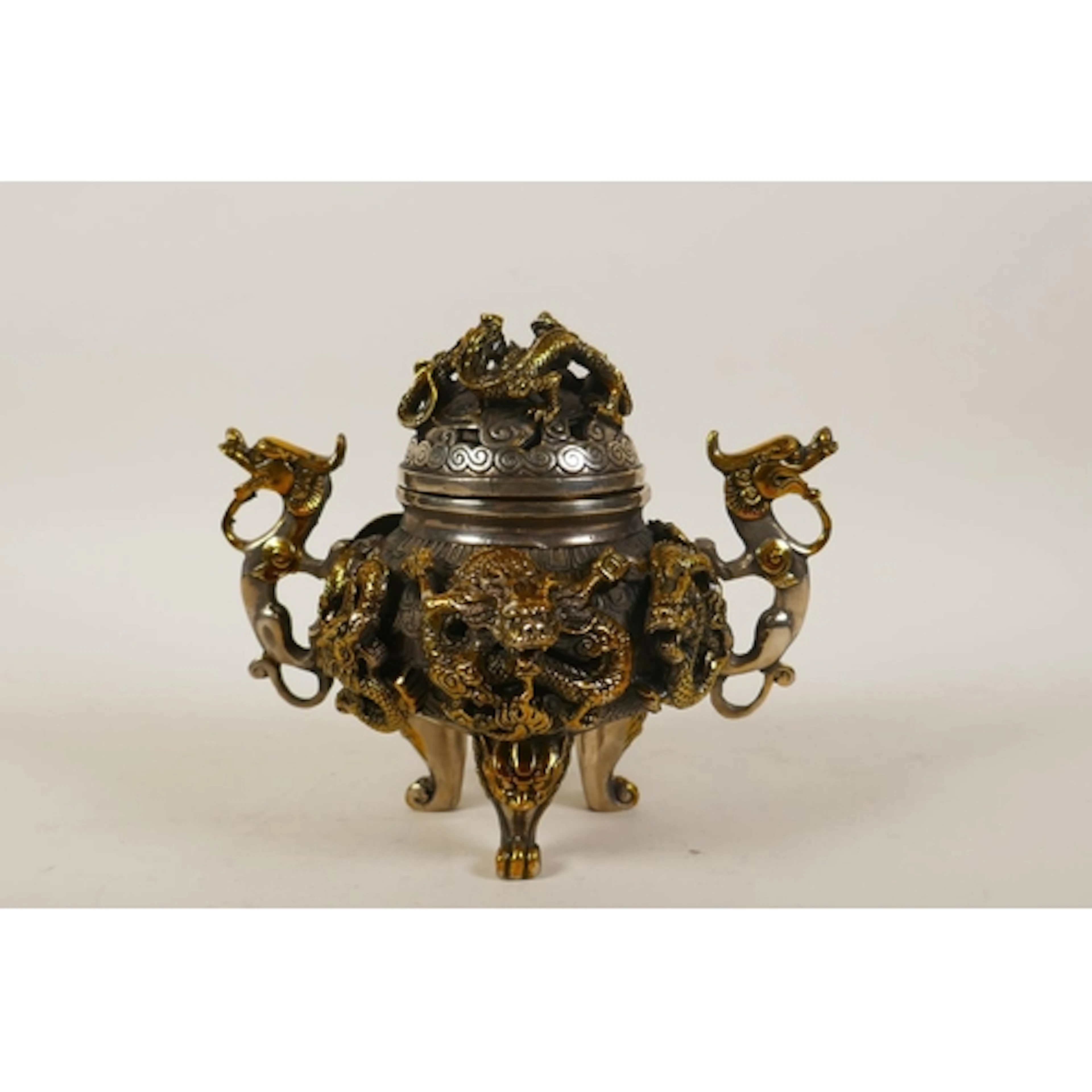 A Chinese silvered metal censer and cover with gilt highligh...