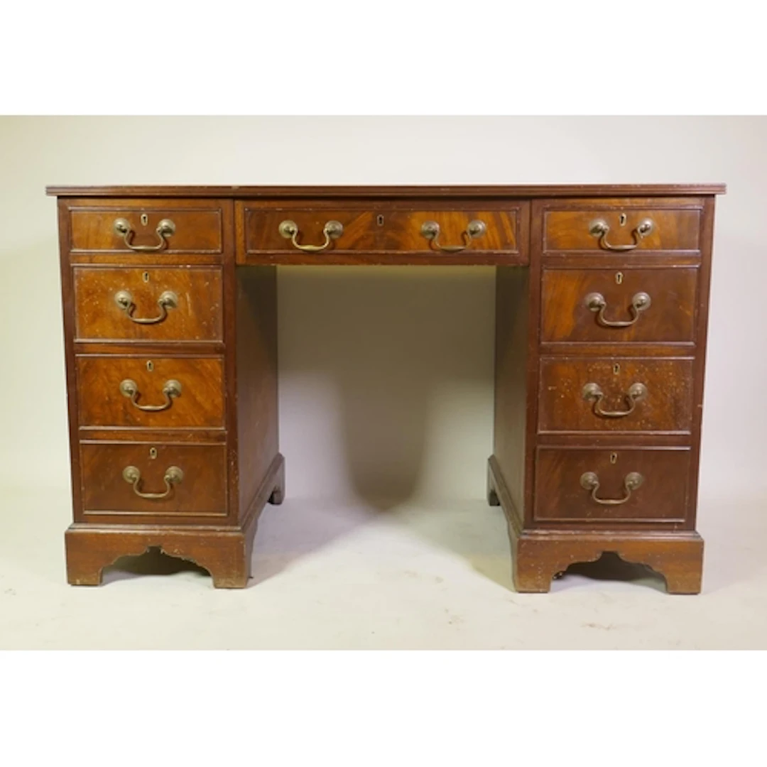 A Victorian style mahogany kneehole desk of nine drawers wit...