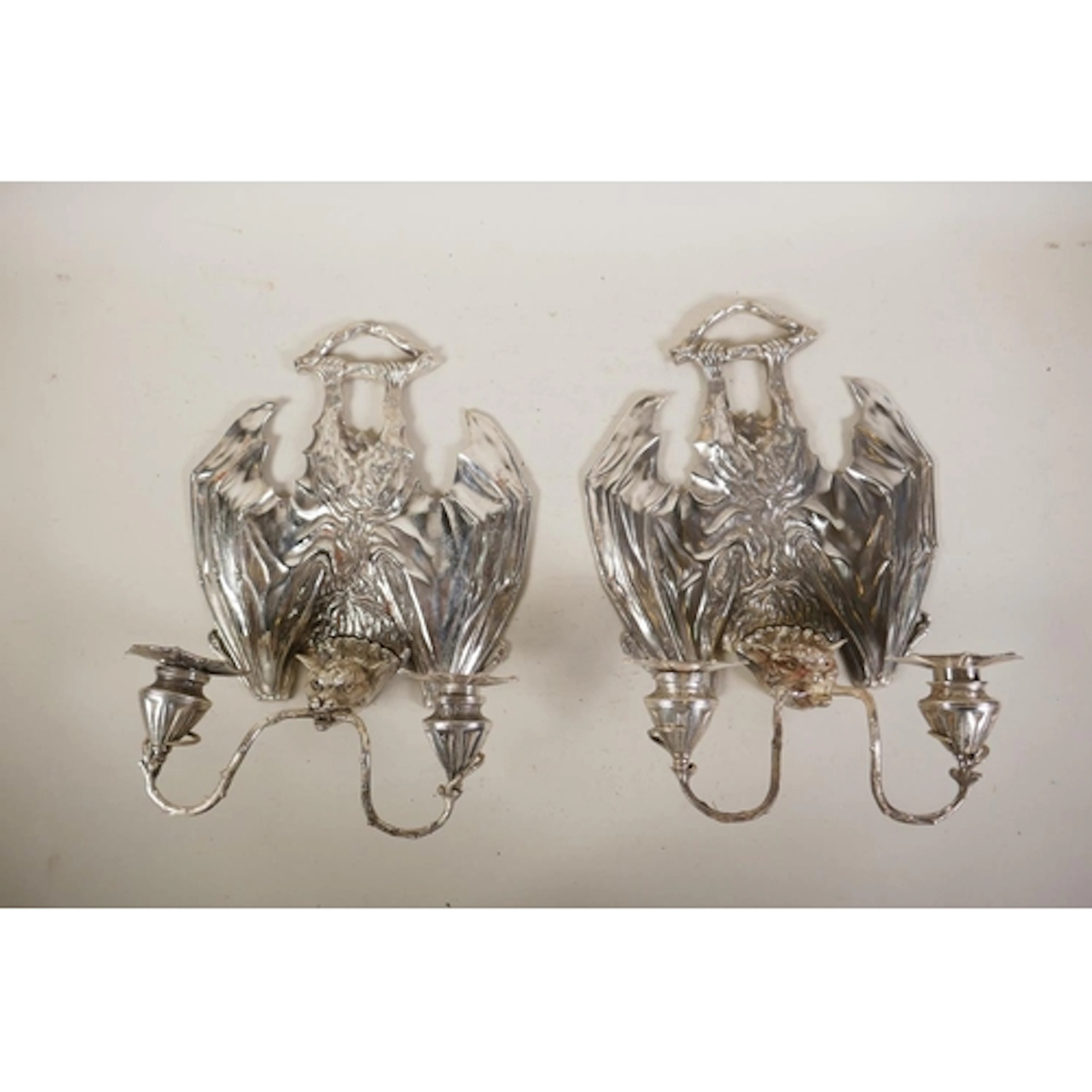 A pair of Gothic style plated metal two branchy 'bat' candle...