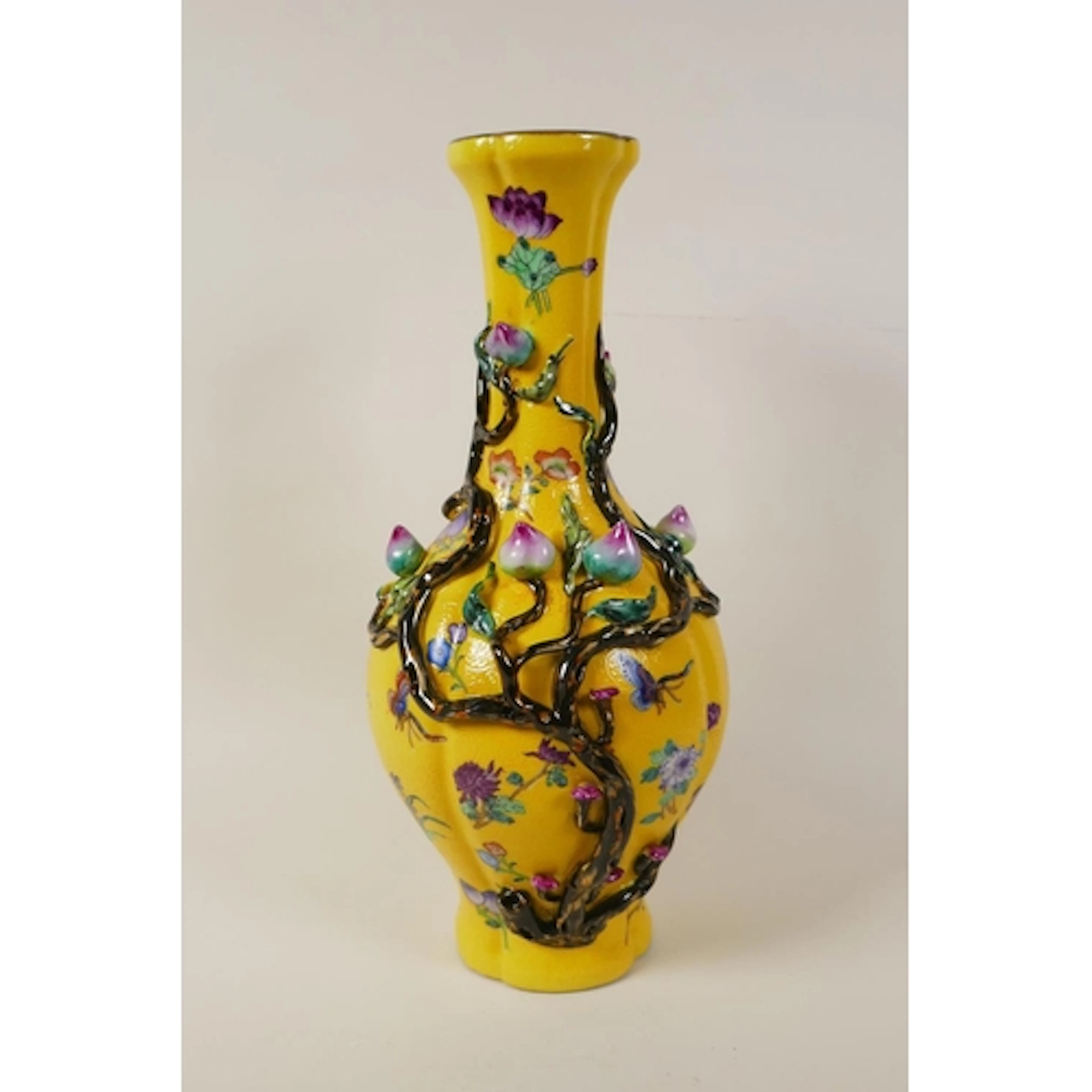 A Chinese yellow ground porcelain vase with applied polychro...