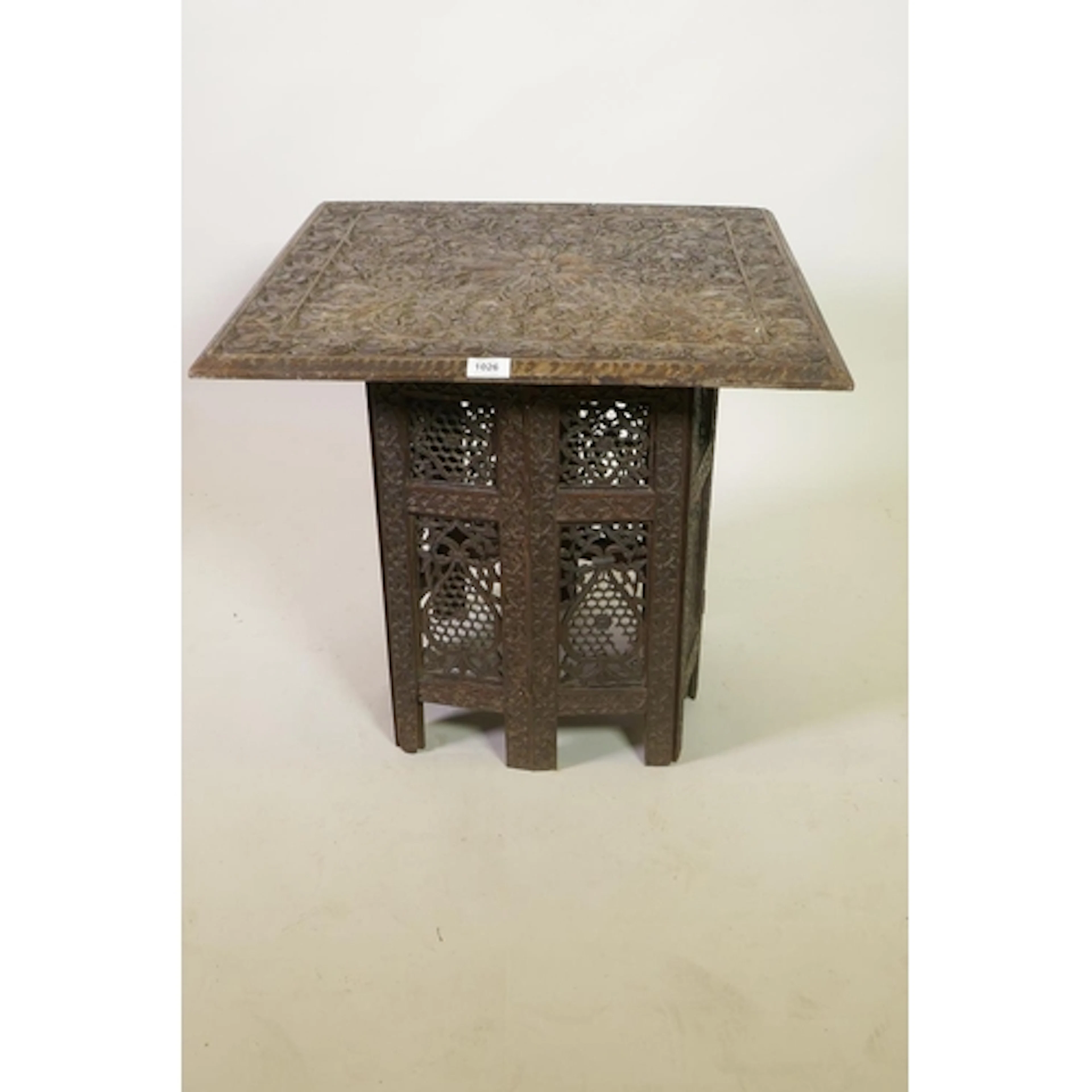 A C19th Burmese carved wood table top with foliate design, a...