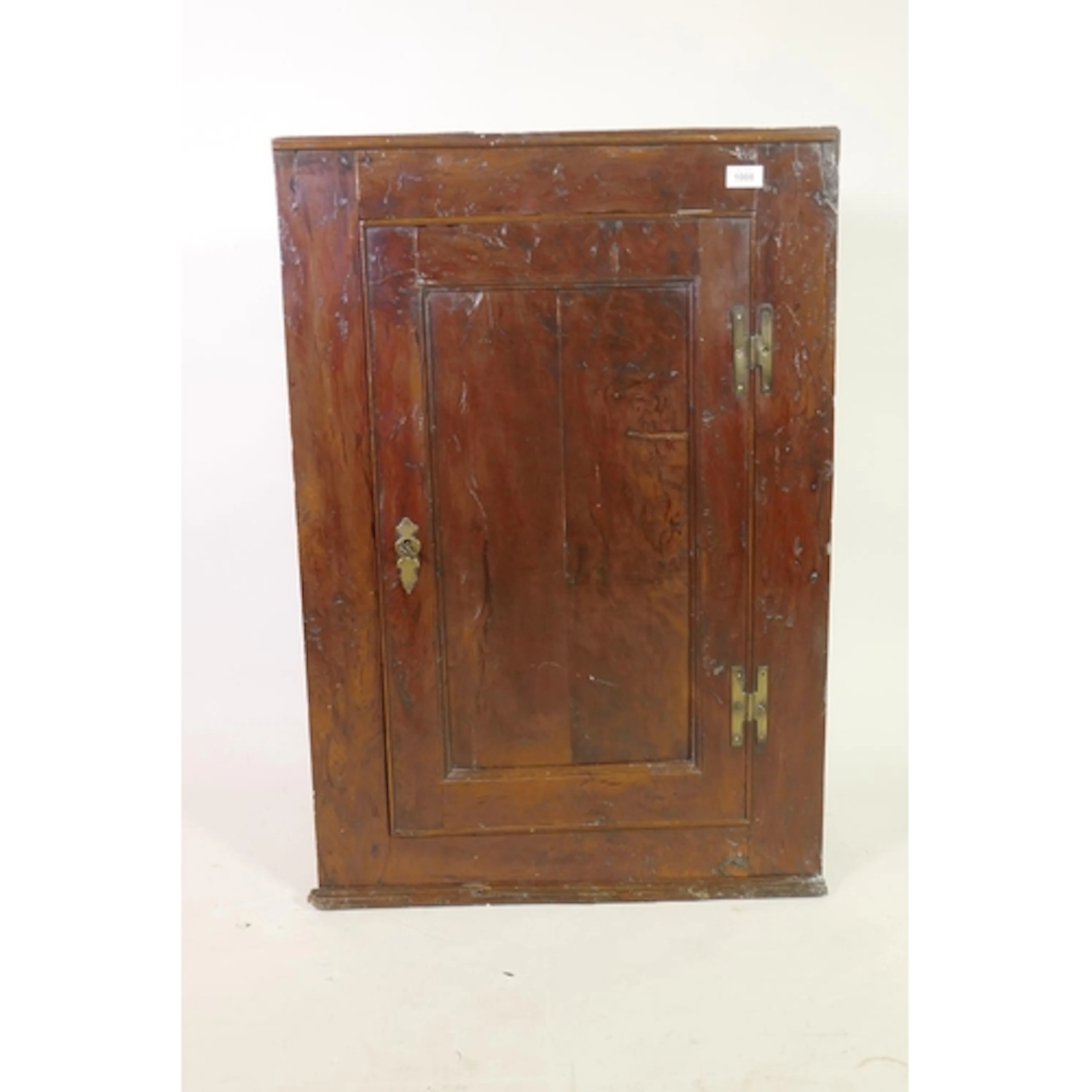 C18th solid yew wood hanging corner cupboard, the interior w...
