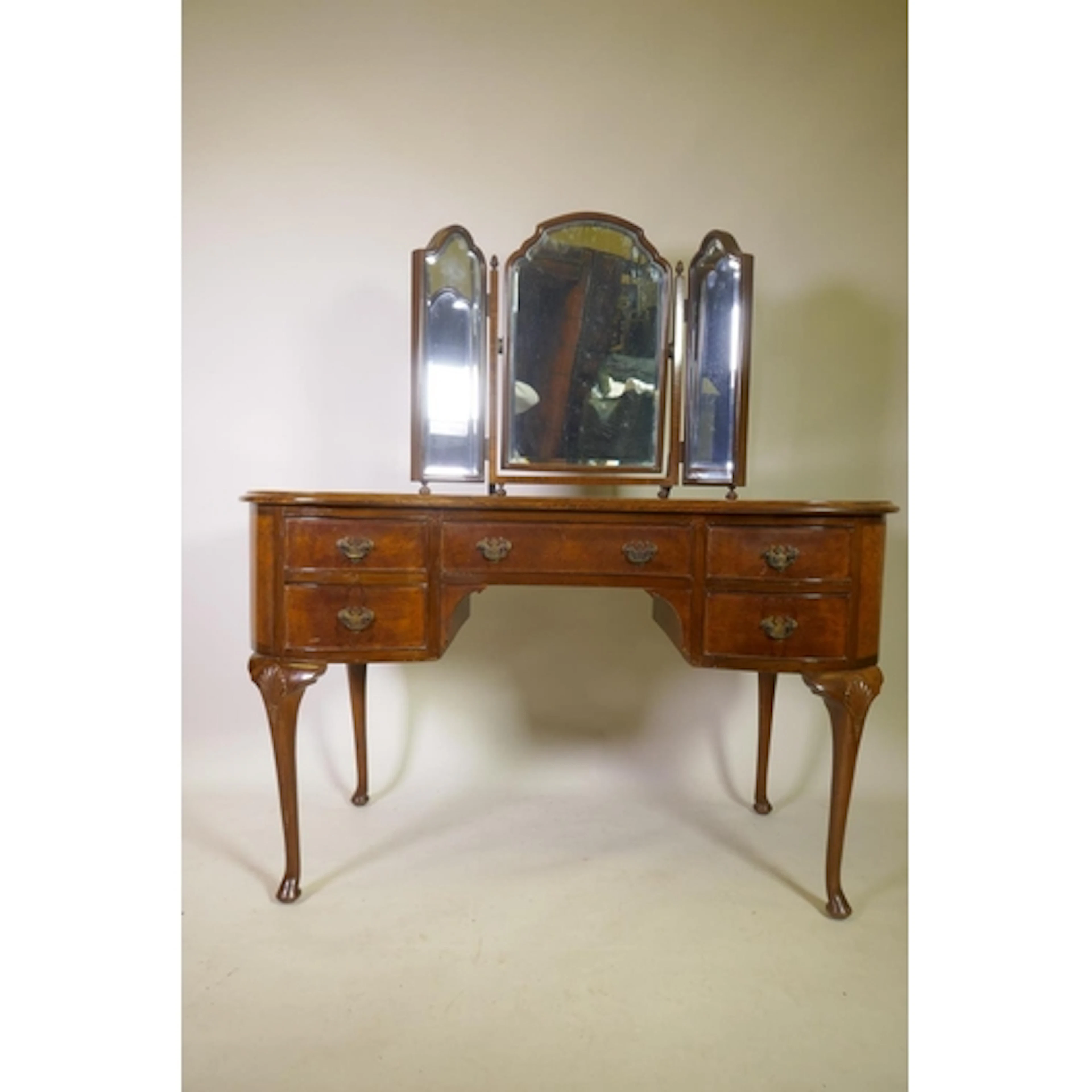 A burr walnut kidney shaped kneehole dressing table of five ...