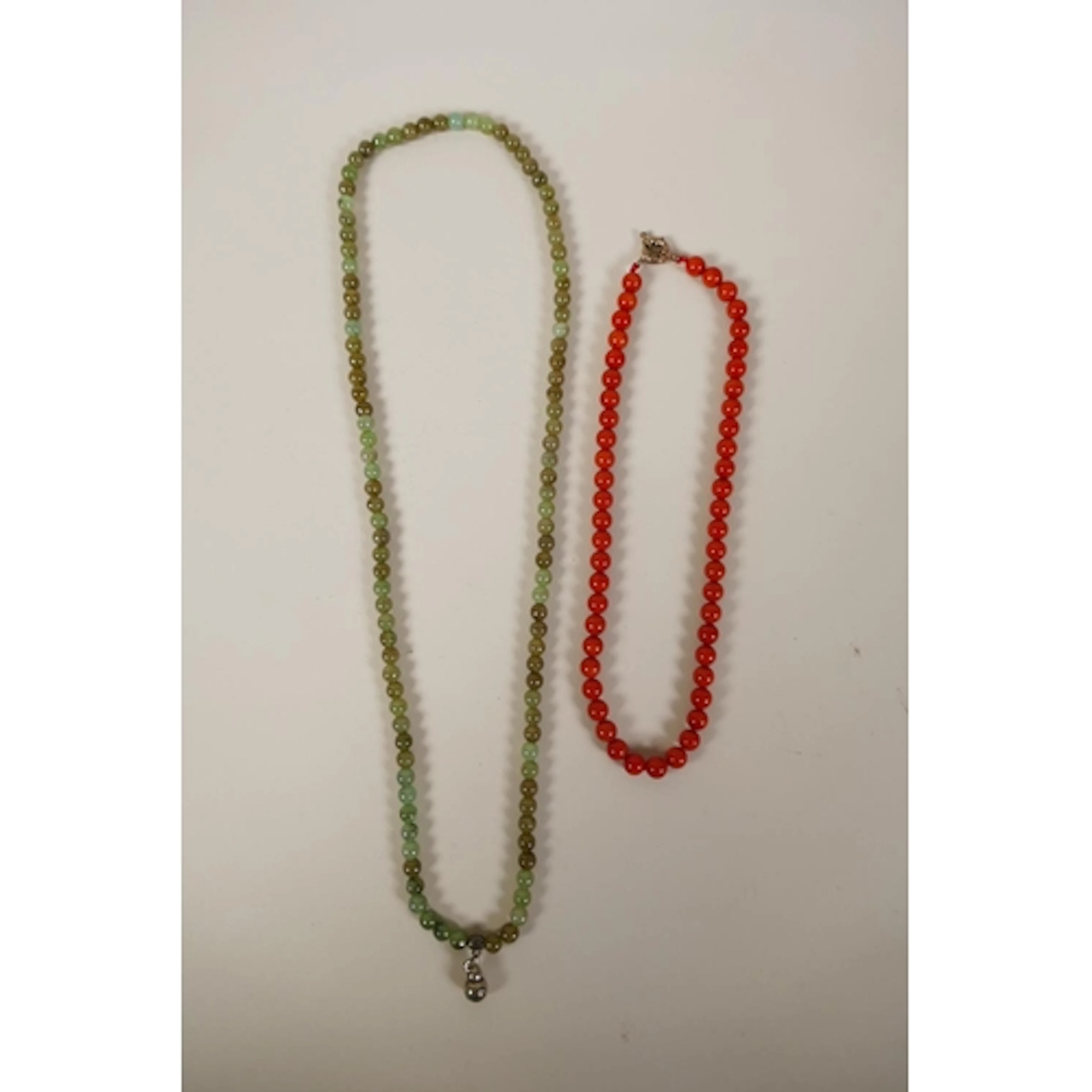 A coral beaded necklace and jade beaded necklace, longest 68...