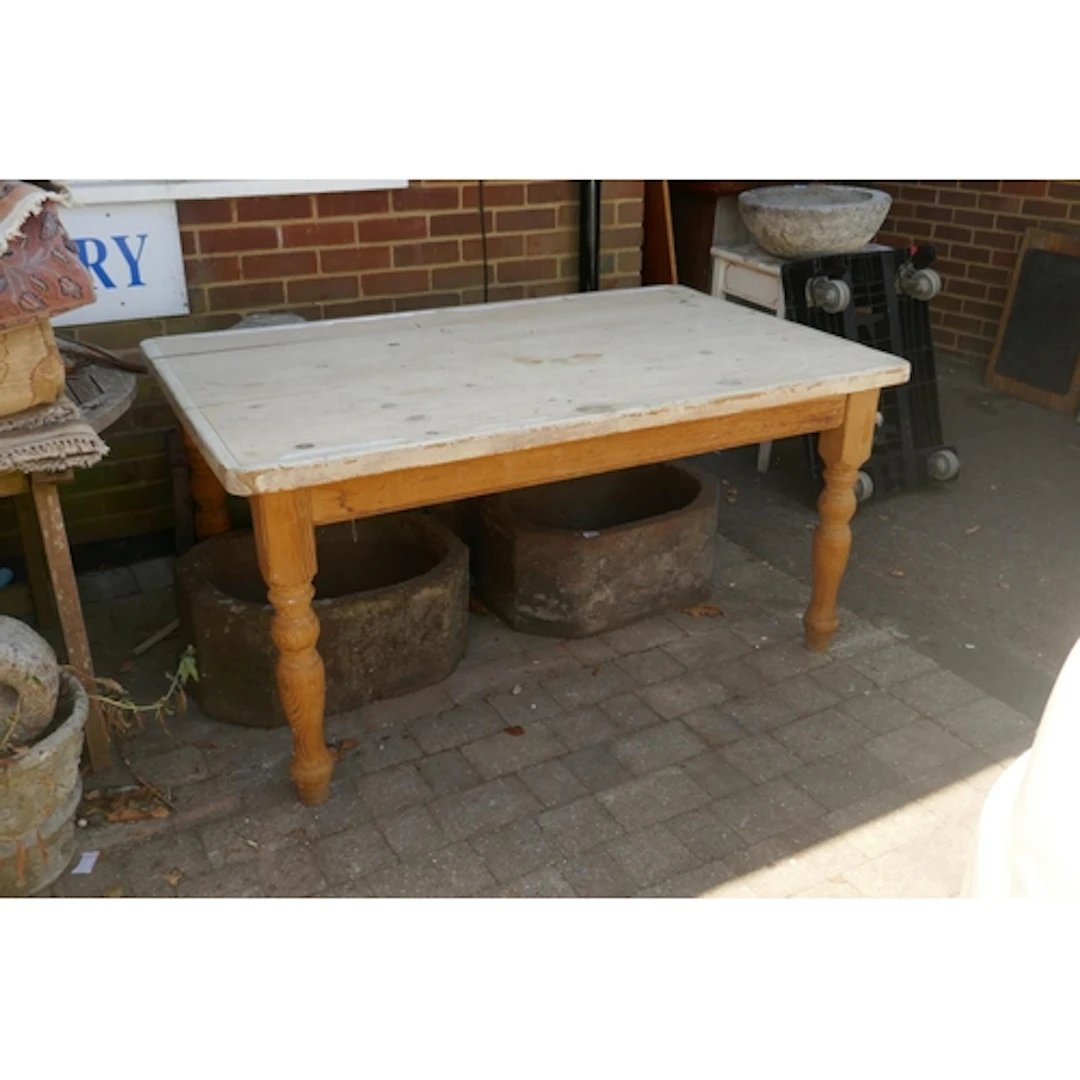 A pine scullery/kitchen table with bleached top raised on tu...