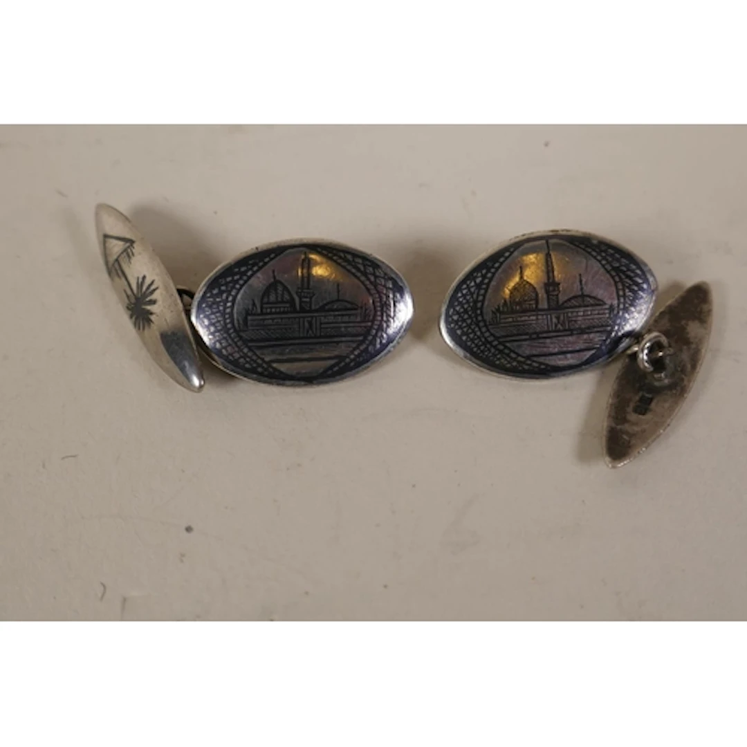 Pair of Arab silver cufflinks, with engraved decoration of a...