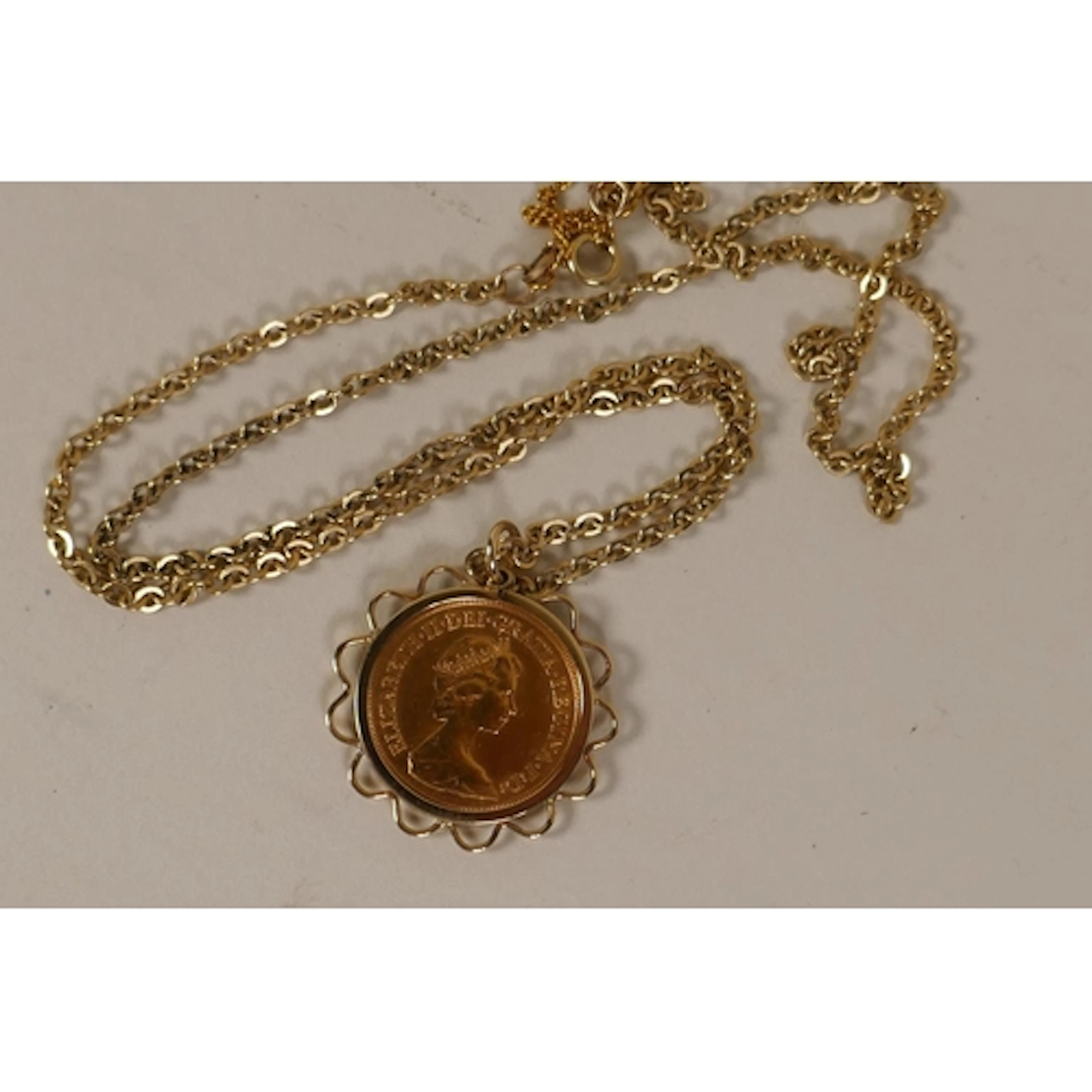 Elizabeth II gold sovereign, 1981, in a 9ct gold mount and c...